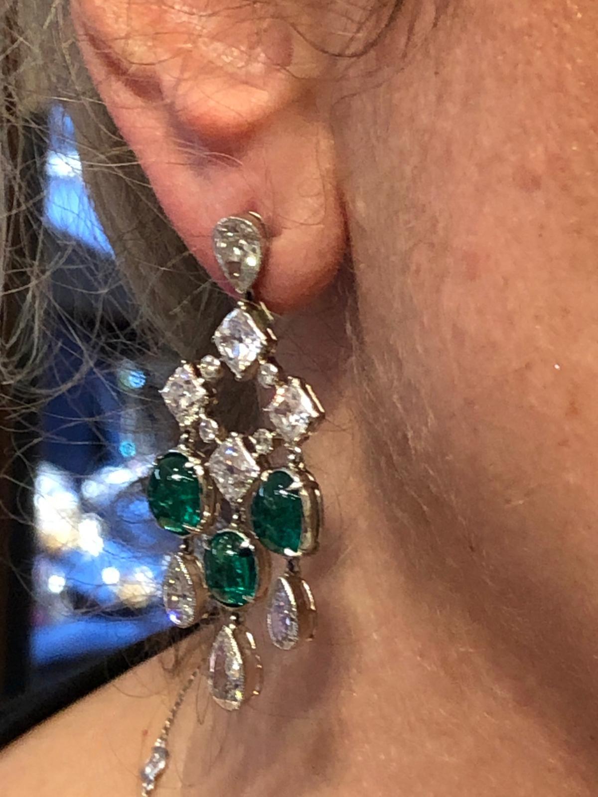 Platinum Diamond, Colombian Emerald Earrings.
A pair of platinum earrings, set with diamonds and six Colombian emeralds.
Measures approx. 2″ in length by 0.87″ in width; gross weight approx. 18.6 grams
Colombian Emerald weights: 2.14 ,  2.07, 2.05,