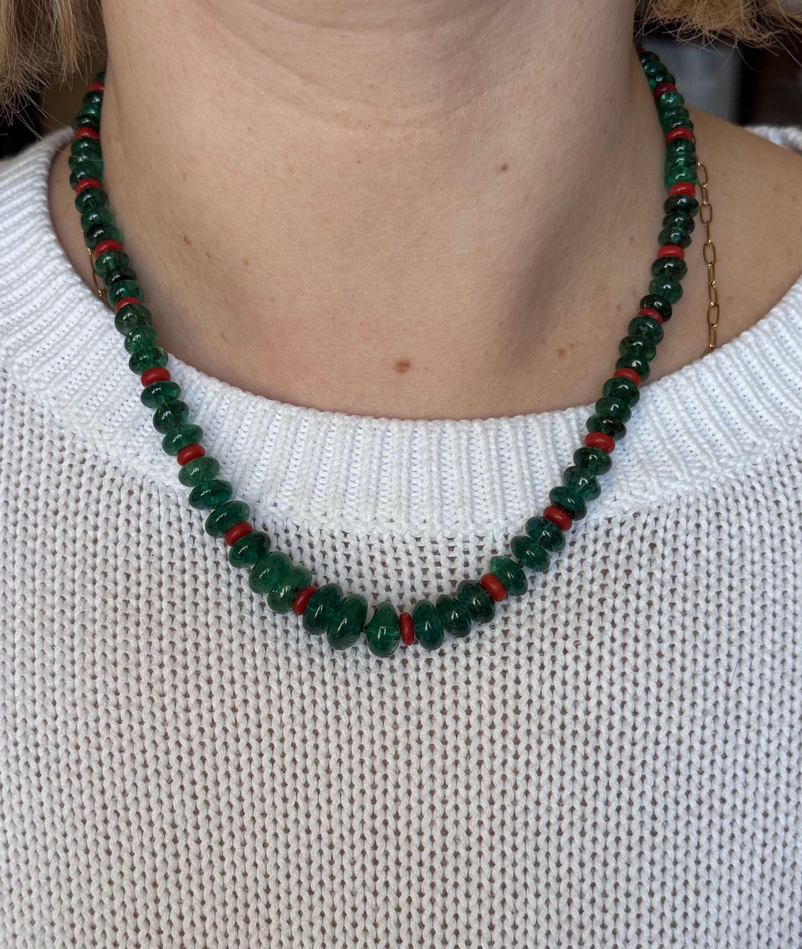 Platinum clasp with approx. 0.40ctw diamonds, featuring emeralds beads, ranging in size from 6mm to 12mm, and coral beads - 5.5mm to 6.3mm. 
Necklace is 19