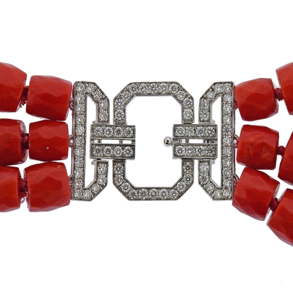 Platinum clasp, adorned with approx. 1.20ctw in diamonds, featuring 3 strands of coral beads. Necklace is 27