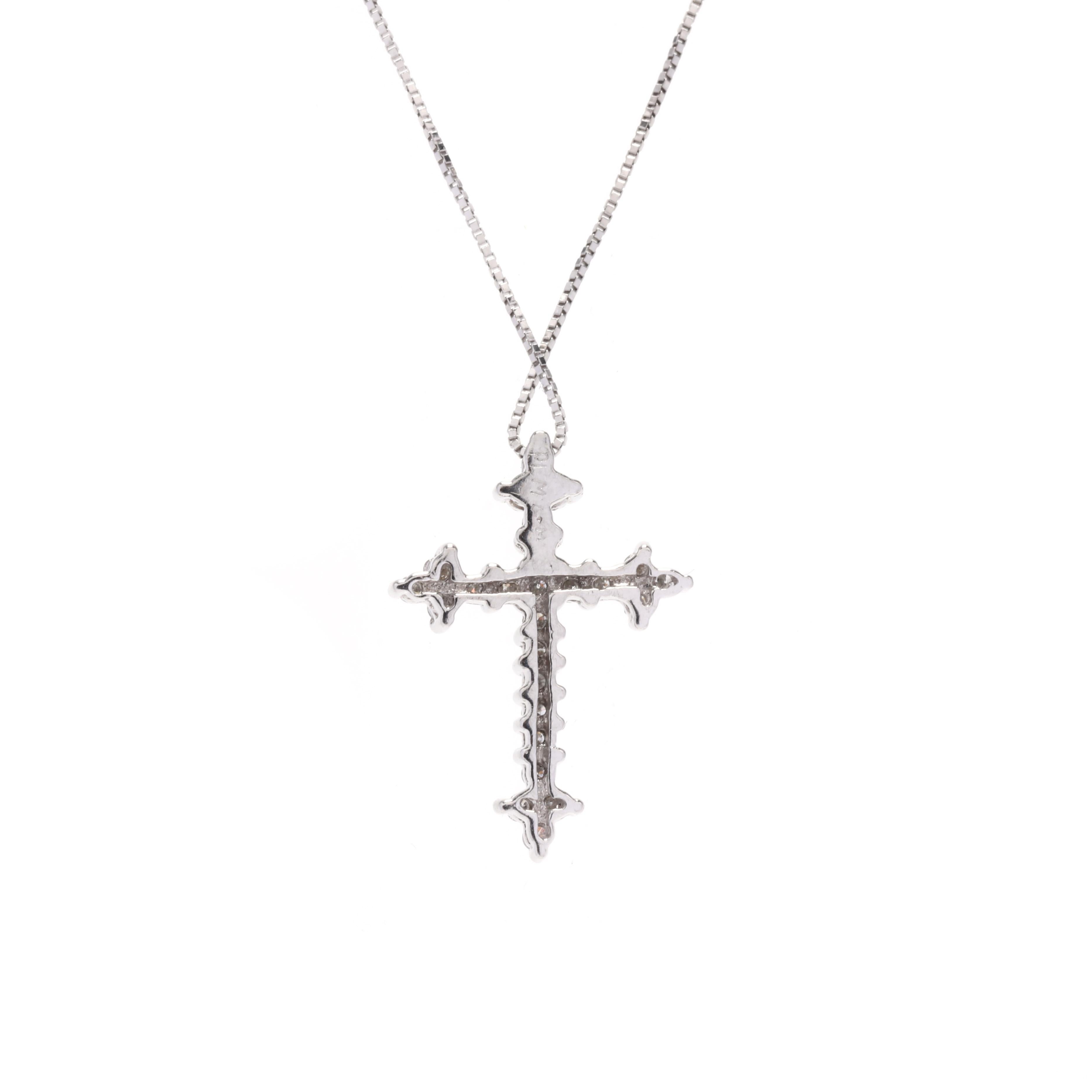 A vintage platinum and diamond cross necklace. This necklace features a cross motif set with full cut round diamonds weighing approximately .25 total carats and suspended from a thin box chain.



Stones:

- diamonds, 25 stones

- full cut round

-