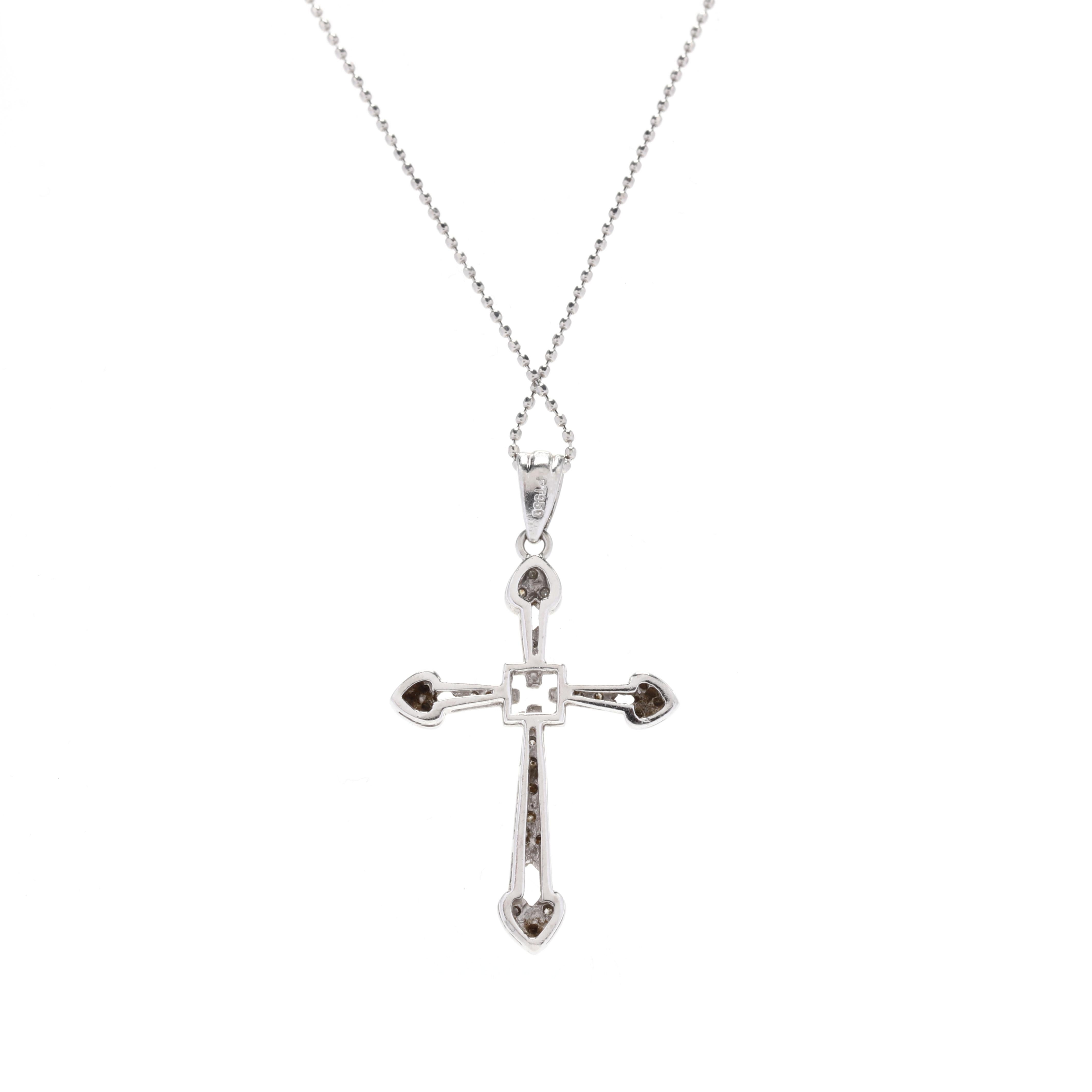 A vintage platinum and diamond cross necklace. This necklace features a cross design with a heart motif at each end, set with full cut round diamonds weighing approximately .15 total carats and suspended from a bead chain.



Stones:

- diamonds, 24