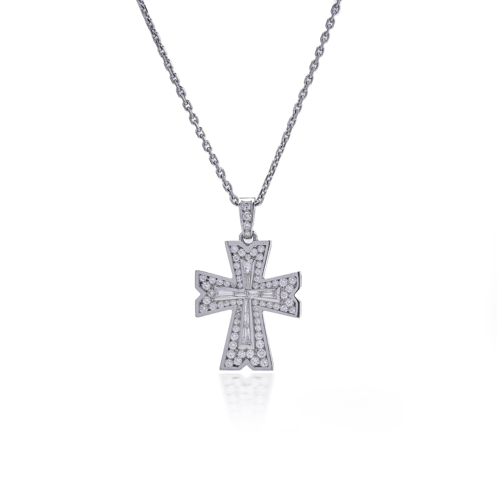 A striking contemporary cross pendant crafted in platinum, pavé-set with round brilliant-cut diamonds and centred with channel-set baguette-cut diamonds in the form of a cross. The highly polished platinum contrasts beautifully with the sparkle of