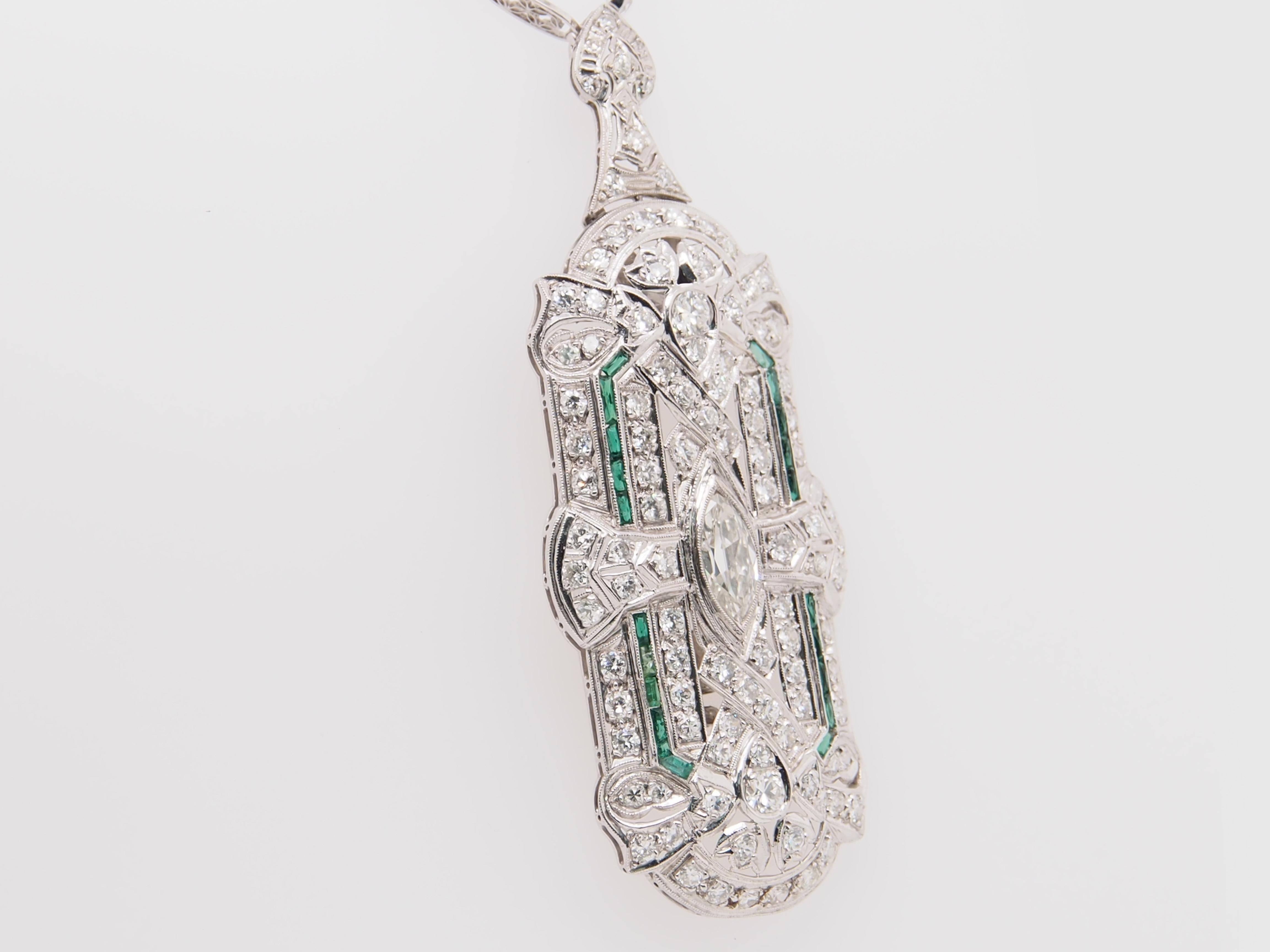 A magnificent Deco Style pendant / brooch / pin and Diamond By The Yard chain in Platinum. The pendant features 1 Marquise Diamond 128 Round Brilliant Cut Diamonds and 20 Baguette Shaped Emeralds. The diamonds weigh 5 carats, G-J in color and VS-SI