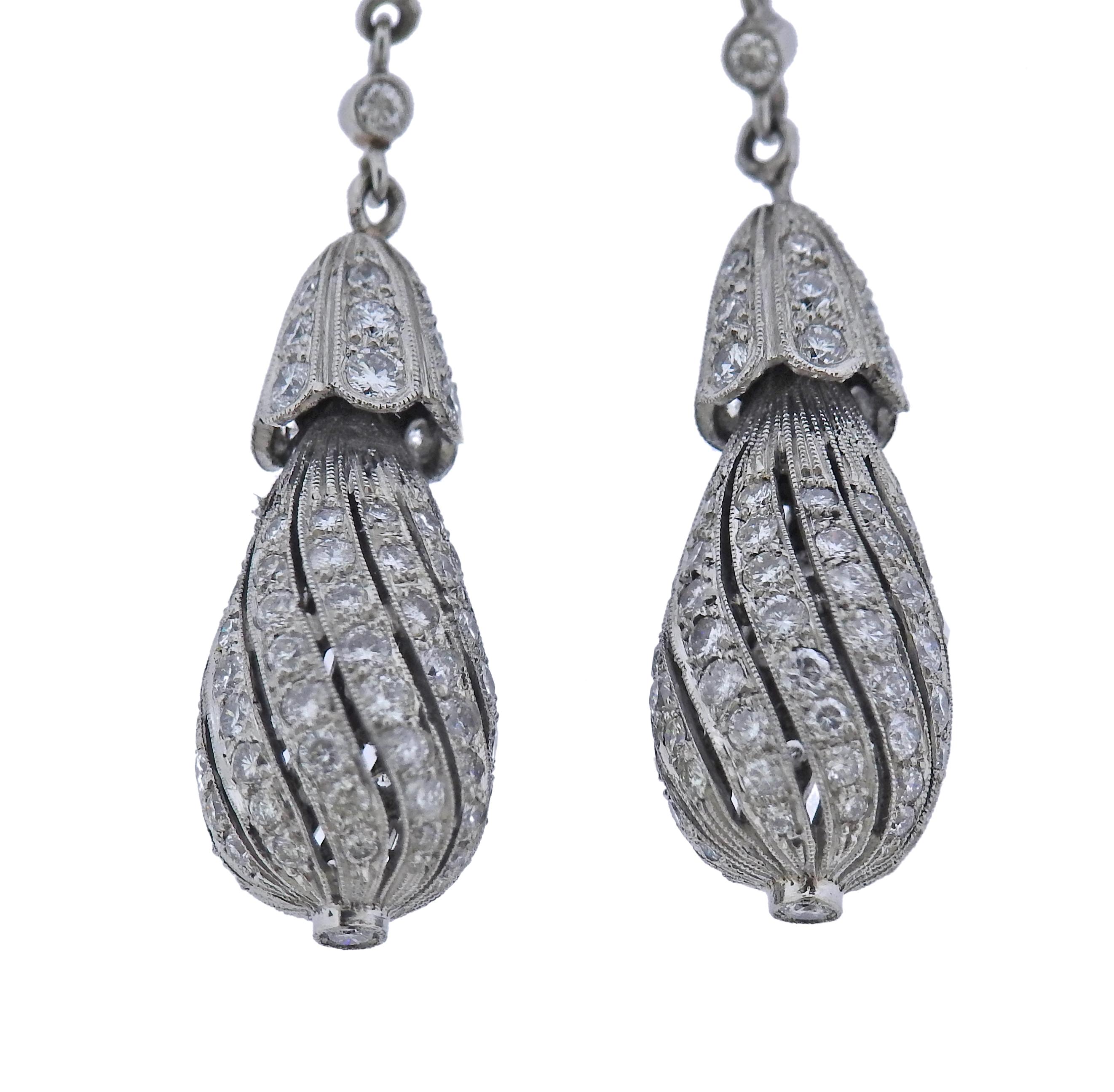 Pair of platinum drop earrings, with gold backs, approx. 1.80ctw in diamonds. Earrings measure 55mm long. Tested plat. gold backs. Weight - 10.6 grams.