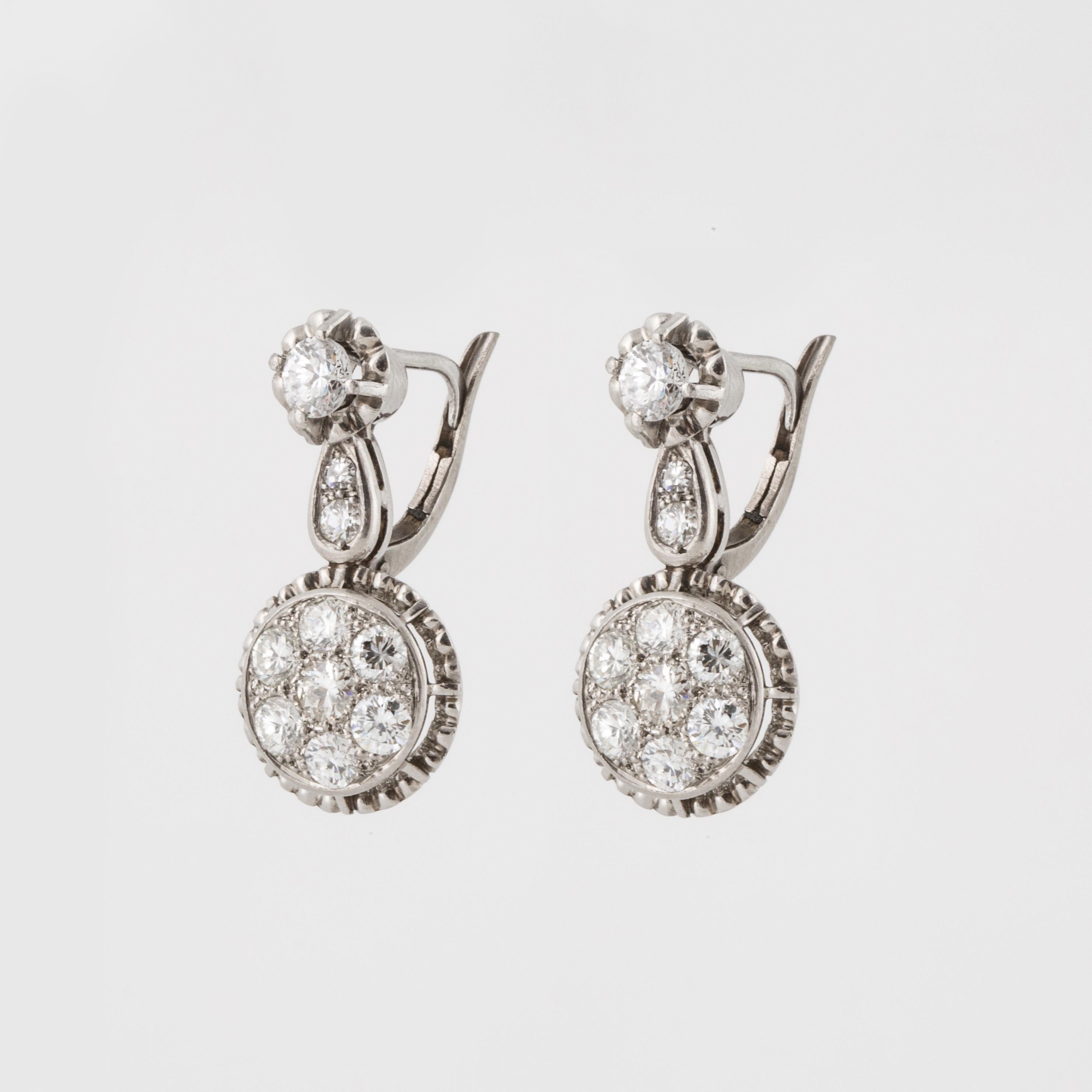 Platinum diamond earrings with 18K white gold backs.  Vintage buttercup mounting holding the top diamonds, then a drop of diamonds in a circle.  There are a total of 20 round diamonds that total 1.90 carats; H-J color and VS1-SI2 clarity.  They