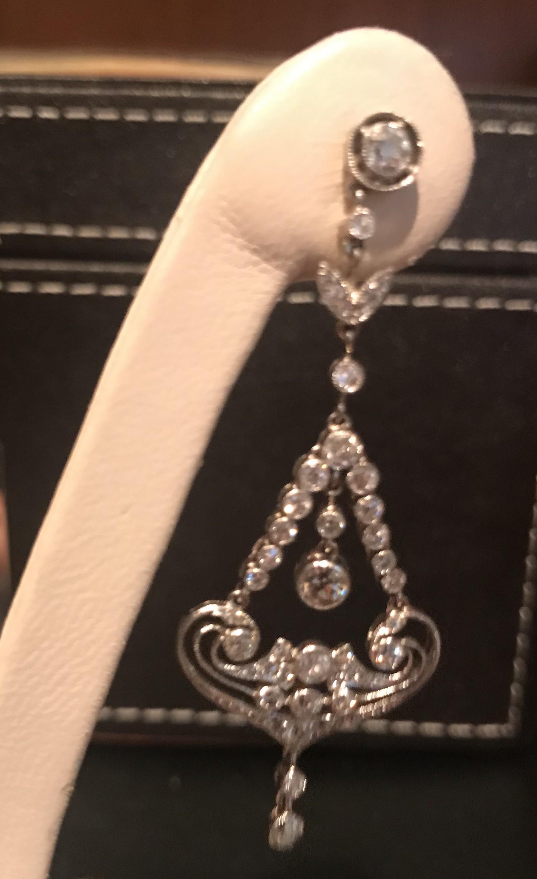 A pair of diamond drop earrings, in a chandelier style design, with open work, set with round brilliant-cut diamonds, mounted in platinum, with a total diamond weight 2.46ct. 
Drop 5.5cm