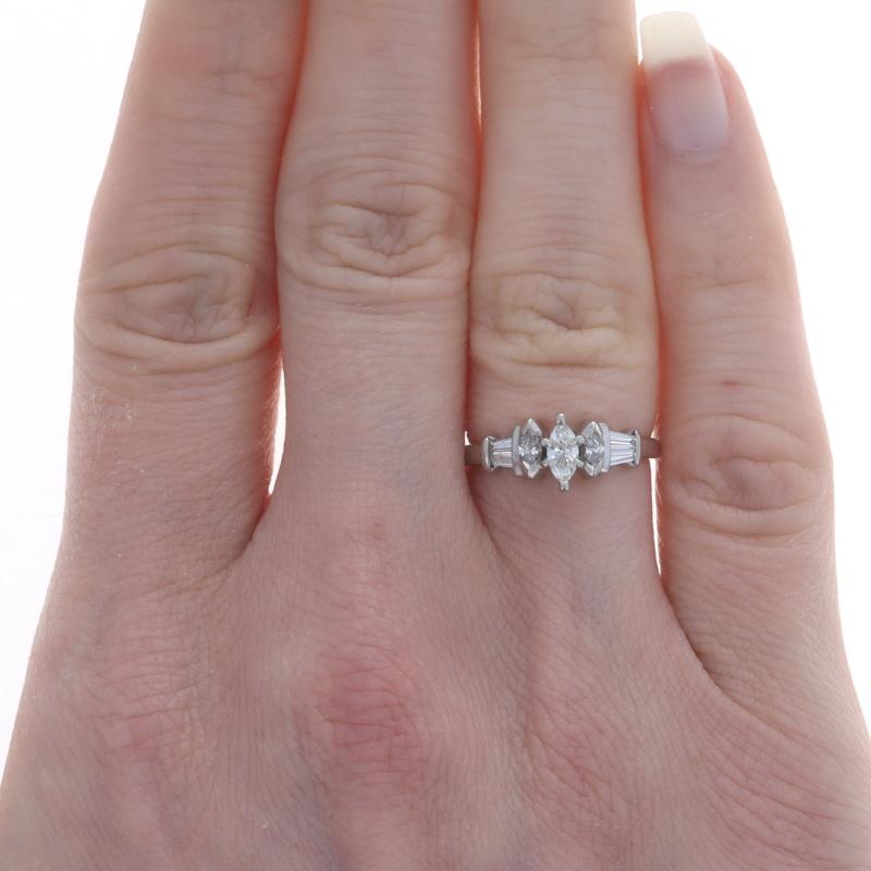 Size: 5

Metal Content: 950 Platinum

Stone Information
Natural Diamonds
Carat(s): .70ctw
Cut: Marquise & Baguette
Color: H - I
Clarity: SI1 - SI2

Total Carats: .70ctw

Style: Solitaire with Accents

Measurements
Face Height (north to south): 9/32