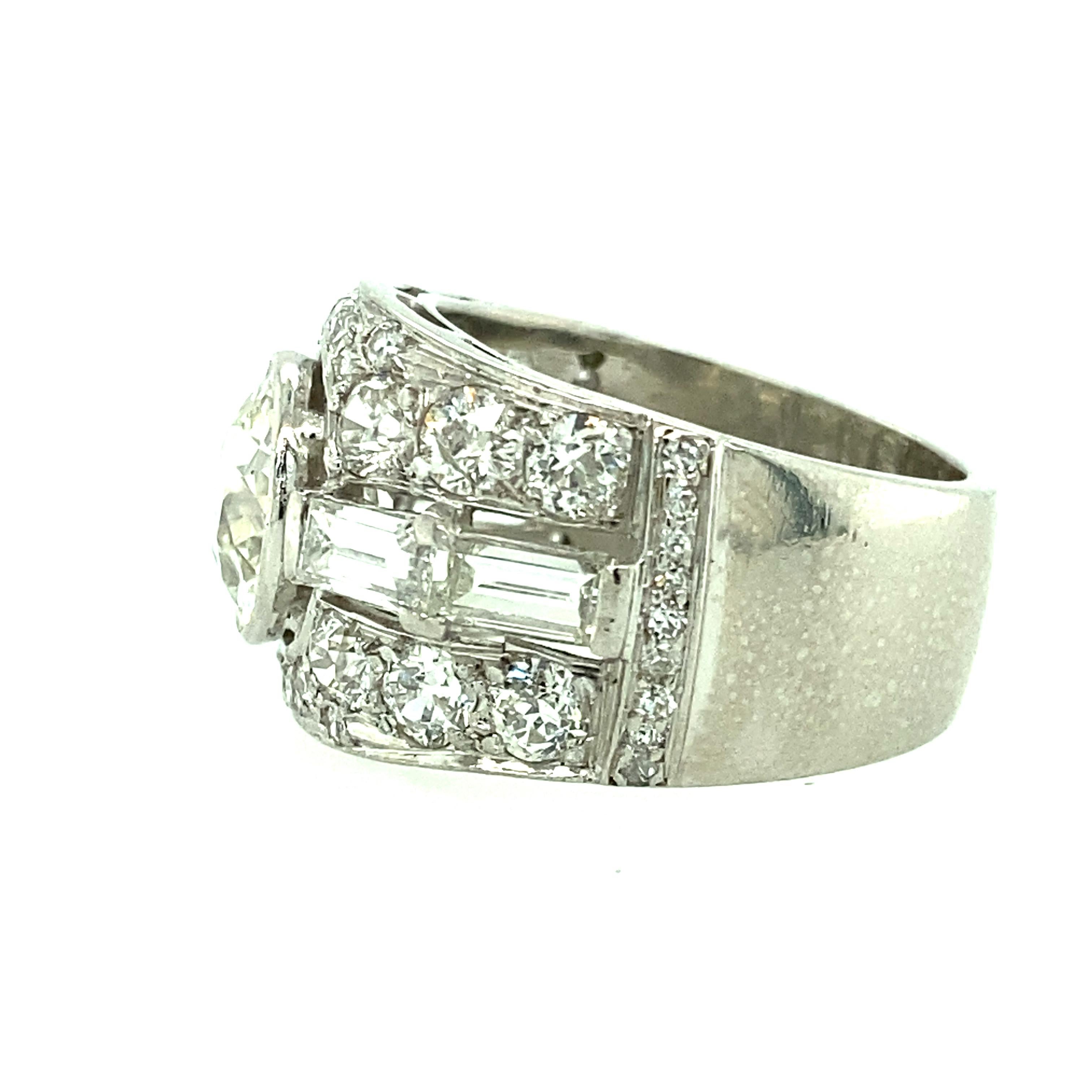 One platinum (stamped IRID PLAT) estate engagement ring set with one 2.25 carat European cut diamond, thirty 1.25 carat total  brilliant cut diamonds and four baguette diamonds 0.04 carat total weight with matching H/I color and SI clarity. Finger