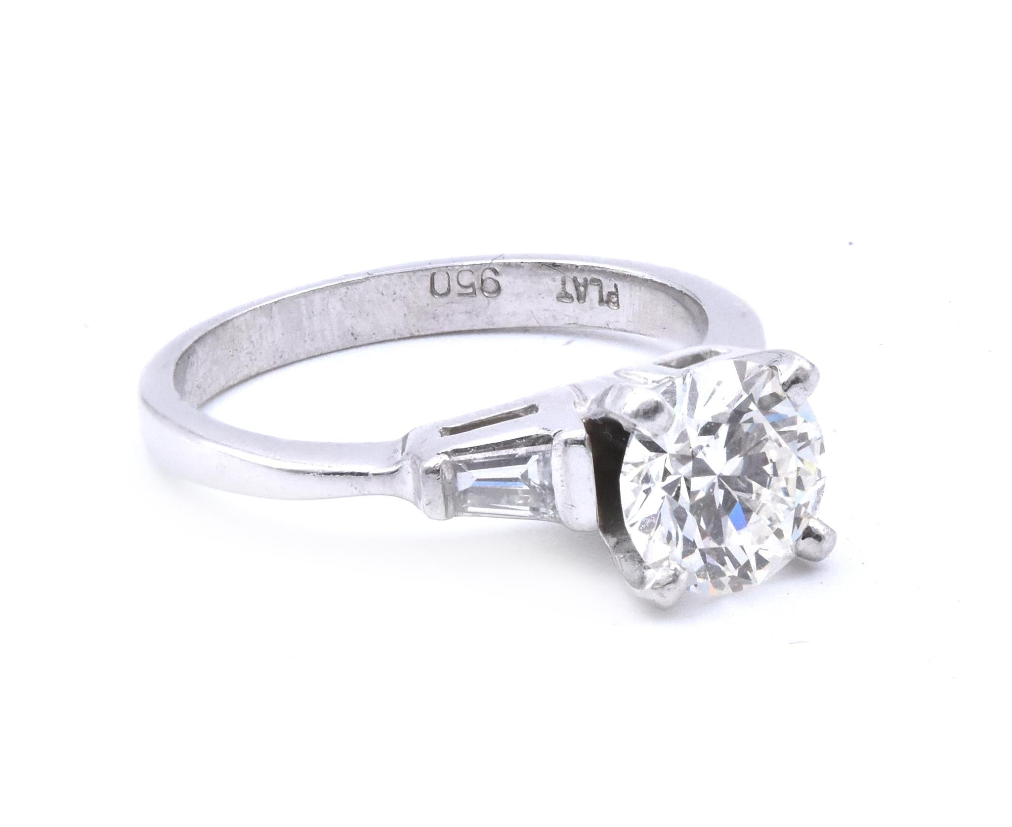 Material: platinum
Center Diamond: 1 round brilliant cut = 1.09ct
Color: H
Clarity: VS1
AGS Cert#: 0005839XXX
Diamonds: 2 baguette cut = 0.20cttw
Color: H
Clarity: VS2
Ring Size: 5  (please allow up to 2 additional business days for sizing