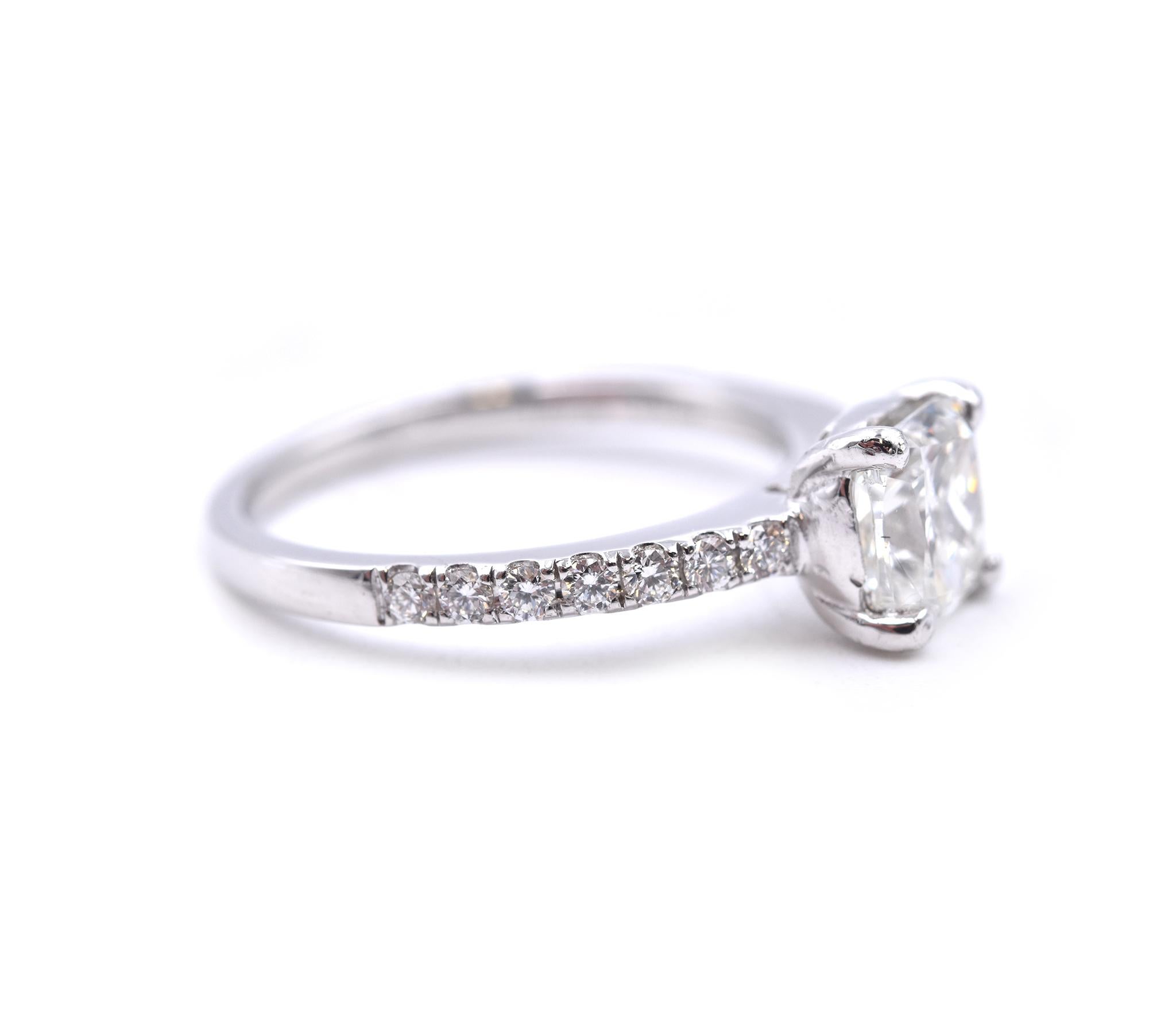 Material: platinum
Center Diamond: 1 cushion cut = 1.40ct
Color: I
Clarity: SI2
Diamonds: 14 round brilliant cut = .50cttw
Color: G
Clarity: VS
Ring Size: 7  (please allow up to 2 additional business days for sizing requests)
Dimensions: ring