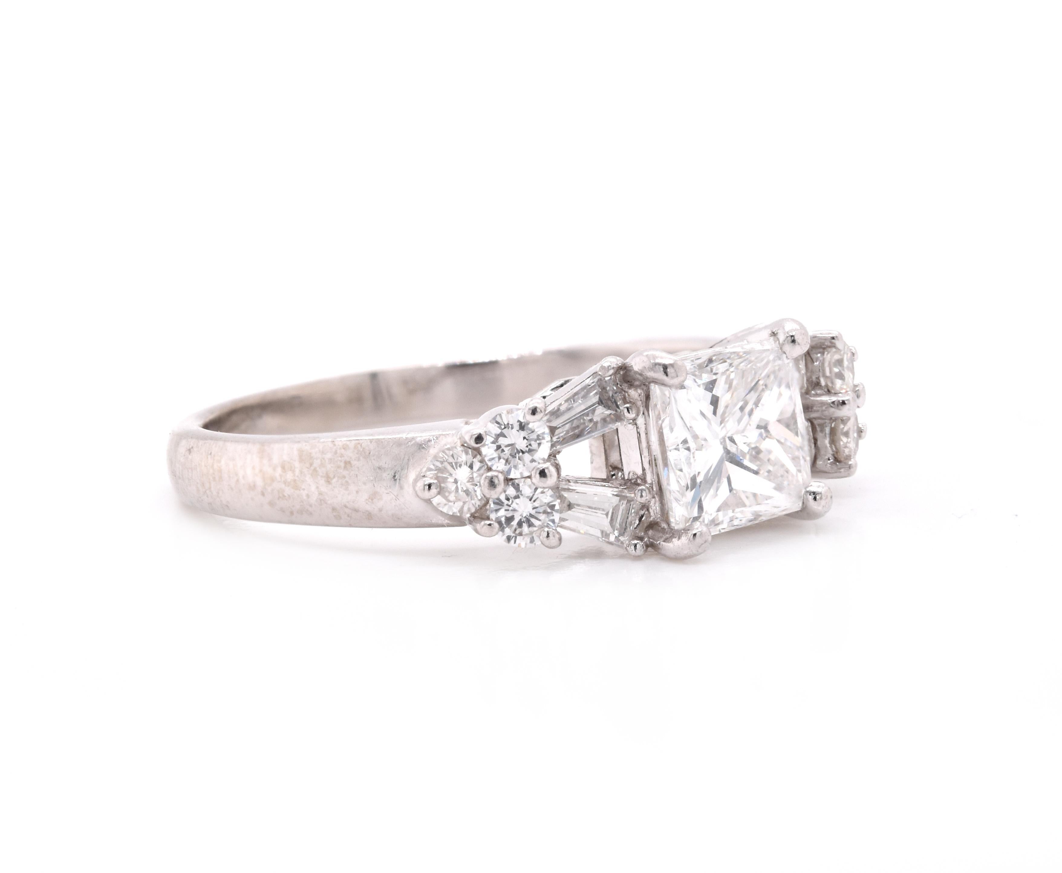 Material: Platinum
Center Diamond: 1 princess cut = 1.05ct
Color: E
Clarity: VS1
Diamonds: 10 round/baguette cut = .46cttw
Color: G
Clarity:  VS
Ring Size: 7 (please allow up to 2 additional business days for sizing requests)
Dimensions: ring shank