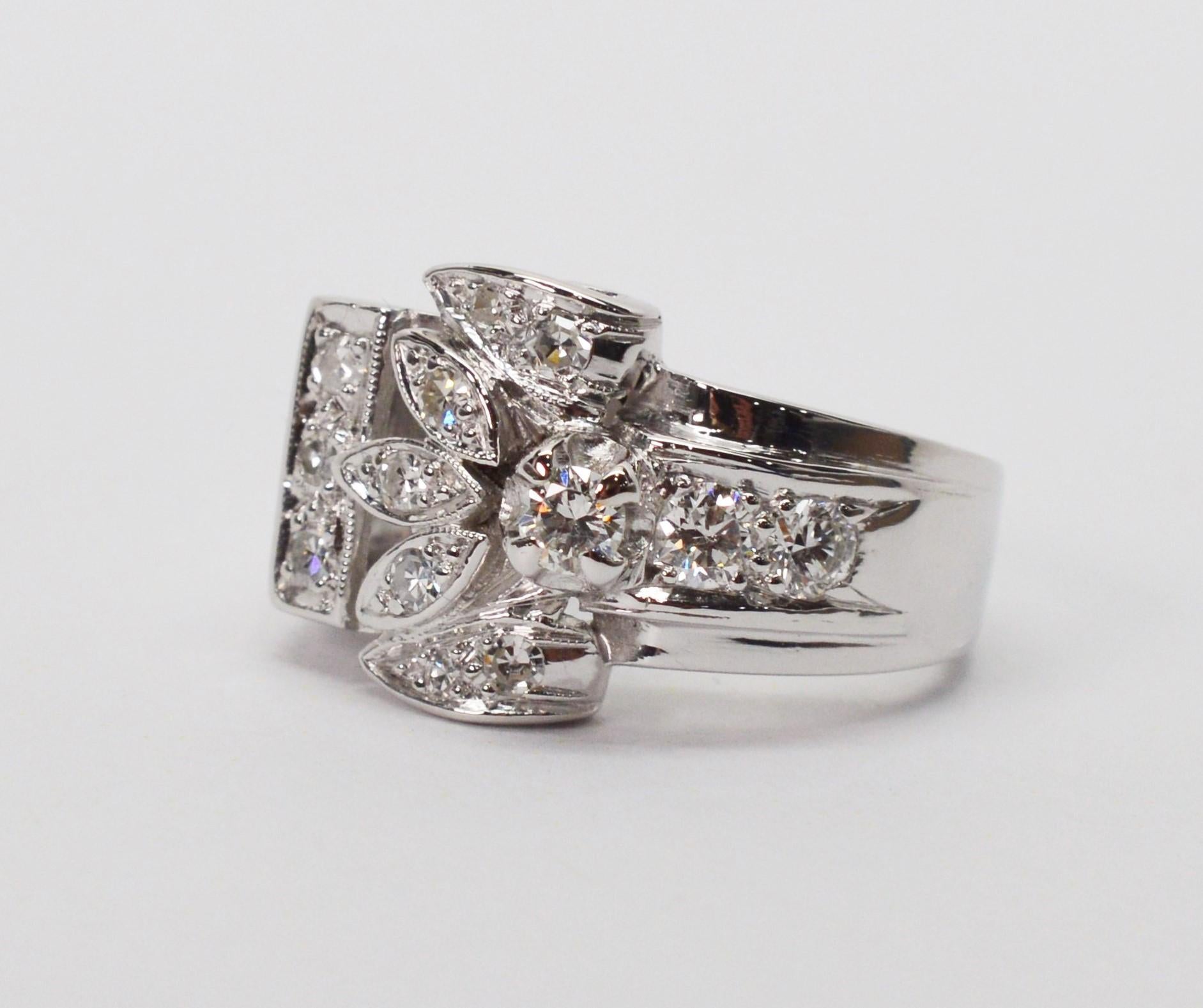 Unique in style as an engagement ring or classic cocktail ring, this stunning diamond .900 platinum wide band ring is sure to catch the eye with its unique wrap design. Nineteen separate H/SI pave set diamonds estimated to total over one carat total