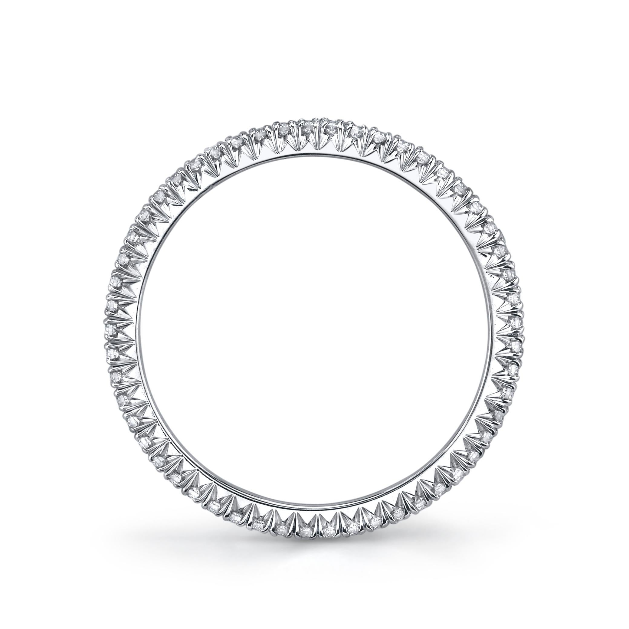 This diamond eternity band is the epitome of timeless elegance and sophistication. With its sleek platinum finish and intricate hearts and arrows design, this ring is a true statement piece. Each of the diamonds has been meticulously cut to ensure