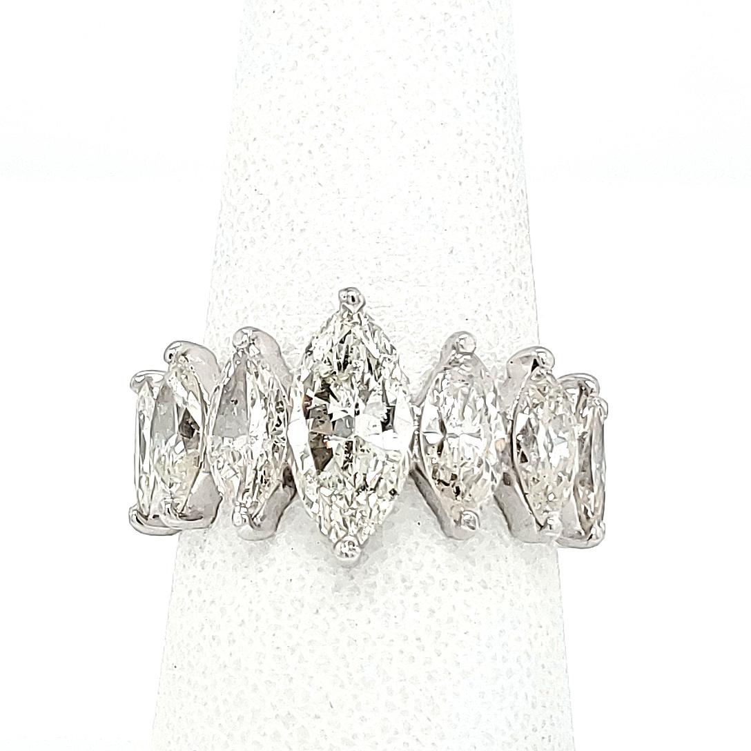 A Unique Eternity Band with Marquise Diamonds set 3/4 around in Platinum. (13) Marquise Diamonds are graduating to an approx 1.3 carat center stone. 5.60 carat total weight of Diamonds, I-J in color and VS-SI in clarity. The center stone is 1/2 inch
