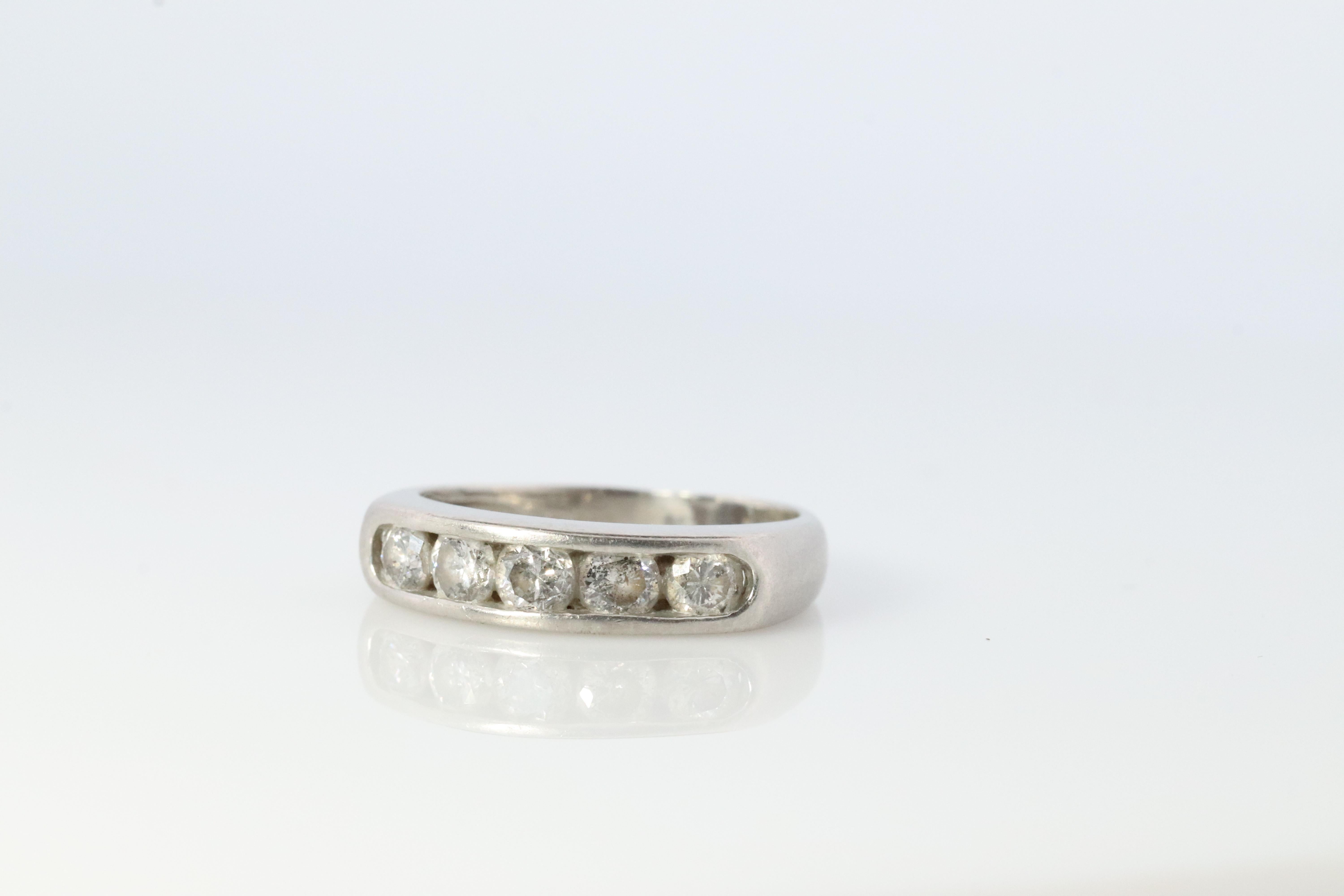 Beautiful Platinum band

1/2ctw Total Diamonds

Half set Anniversary channel set band.

Details:

4mm wide band

5 diamonds total est. 0.5ctw SI clarity H color

3.2grams total

3.25 Ring Size