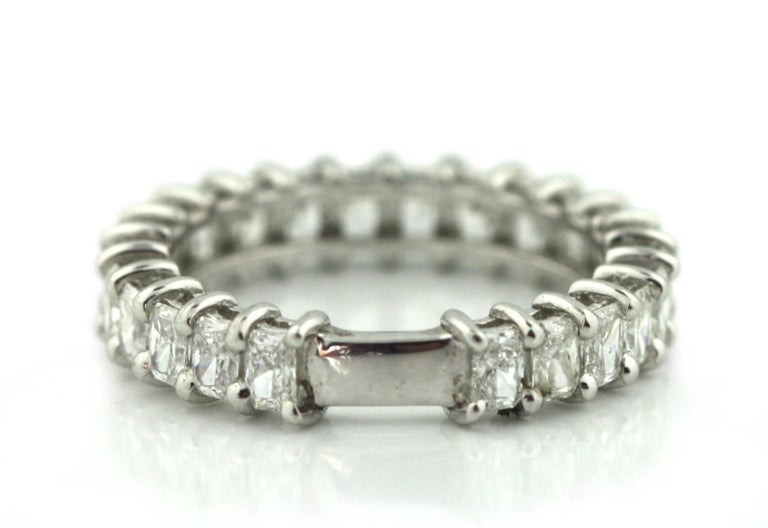 
Platinum Diamond Eternity Band Ring 
Continuously set with radiant cut diamonds, measuring approximately 3.1 x 2.70 mm, weighing approximately 2.28 carats. 
Total weight approximately 4.80 grams.
Size 7
