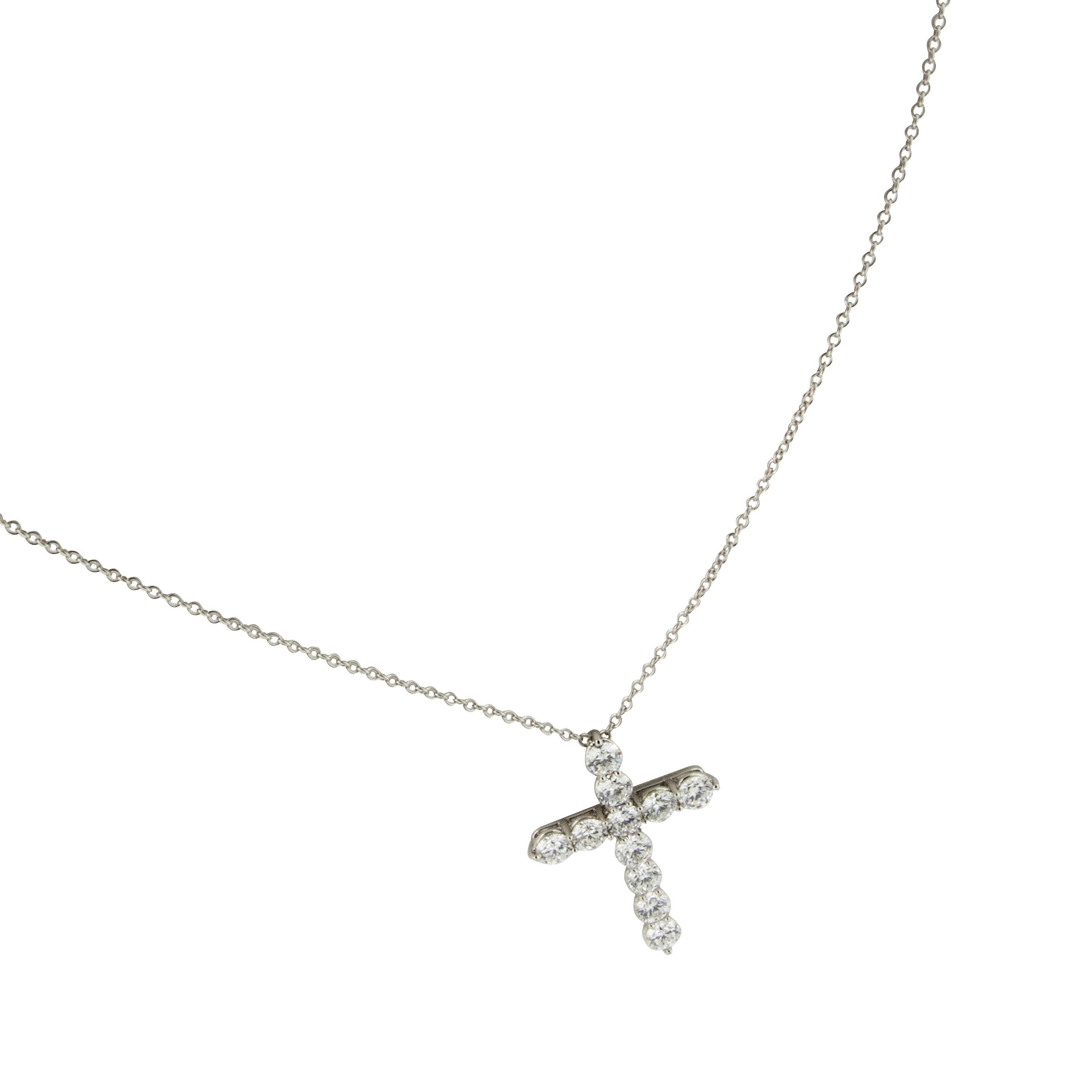 Hand constructed of noble platinum, this timeless diamond cross is set with exceptionally fine diamonds = 1.65 Cttw & being F/G color & VS clarity  suspended on a platinum cable chain 16