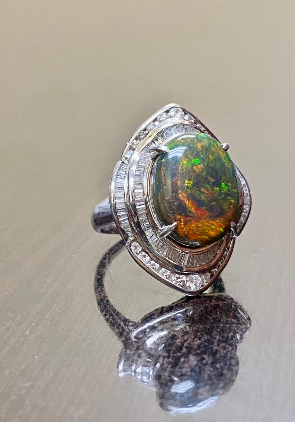 DeKara Designs Collection

Our latest design! An entirely handmade ONE OF A KIND elegant and lustrous Lightning Ridge Australian Black Opal cabochon surrounded by beautiful baguette diamonds in a platinum setting.

Metal- 90% Platinum, 10%