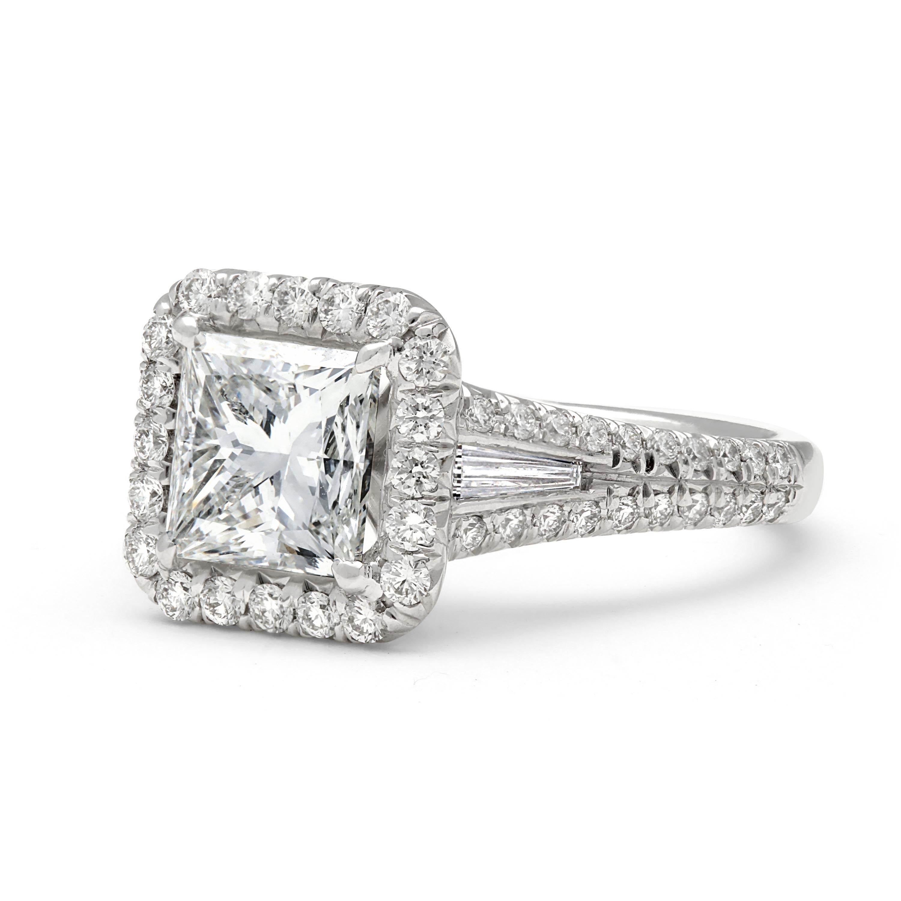 This 3.05 total carat diamond engagement ring is set in platinum and features a stunning 2.19 carat princess cut, I color, VS1 clarity center diamond. The diamond halo and sides offer .67 total carats of round diamonds and .19 carats of tapered