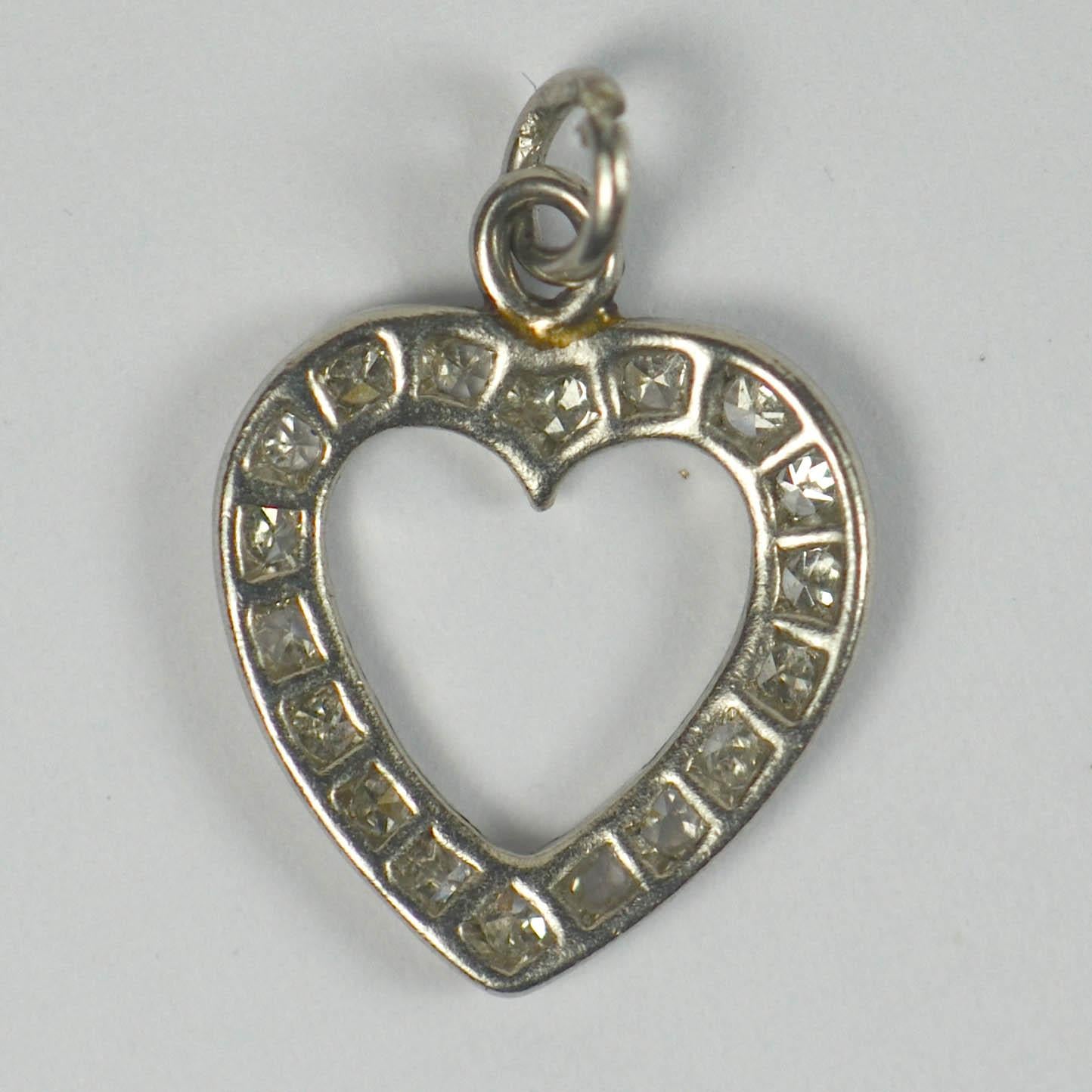 Platinum and diamond charm pendant designed as a heart. 1/2