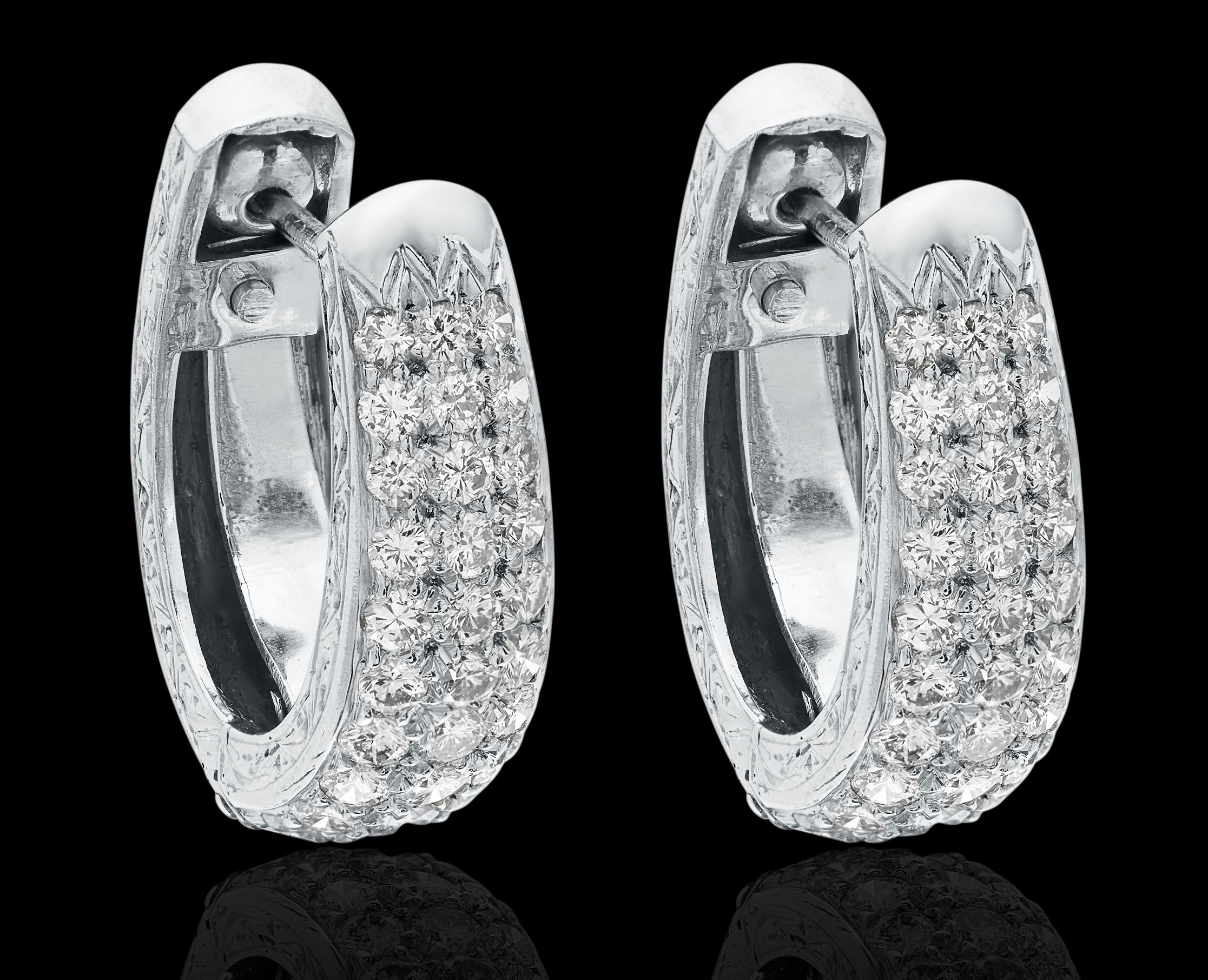 A pair of diamond hoop earrings in easy to wear fittings, subtle and noticeable. The front of the earrings are encrusted with diamonds whilst the back half is inscribed with stunning patterns of leaves and swirls.

Round brilliant cut diamonds,
