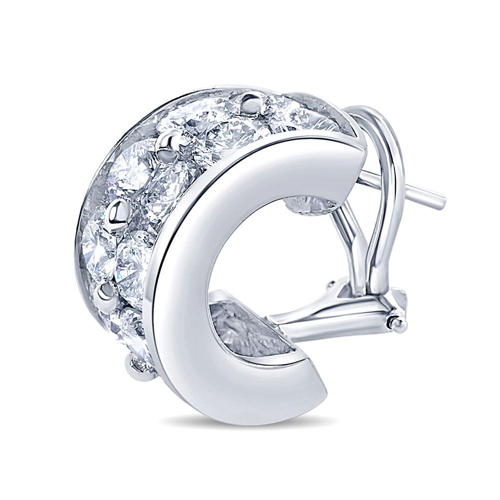 Striking Huggies earrings set in hand made platinum with oversize Diamonds creating a brilliant effect. The brilliantly cut diamonds used in these earrings are near colorless and VS clarity, weighing approx. 7 carats total weight.
These are a
