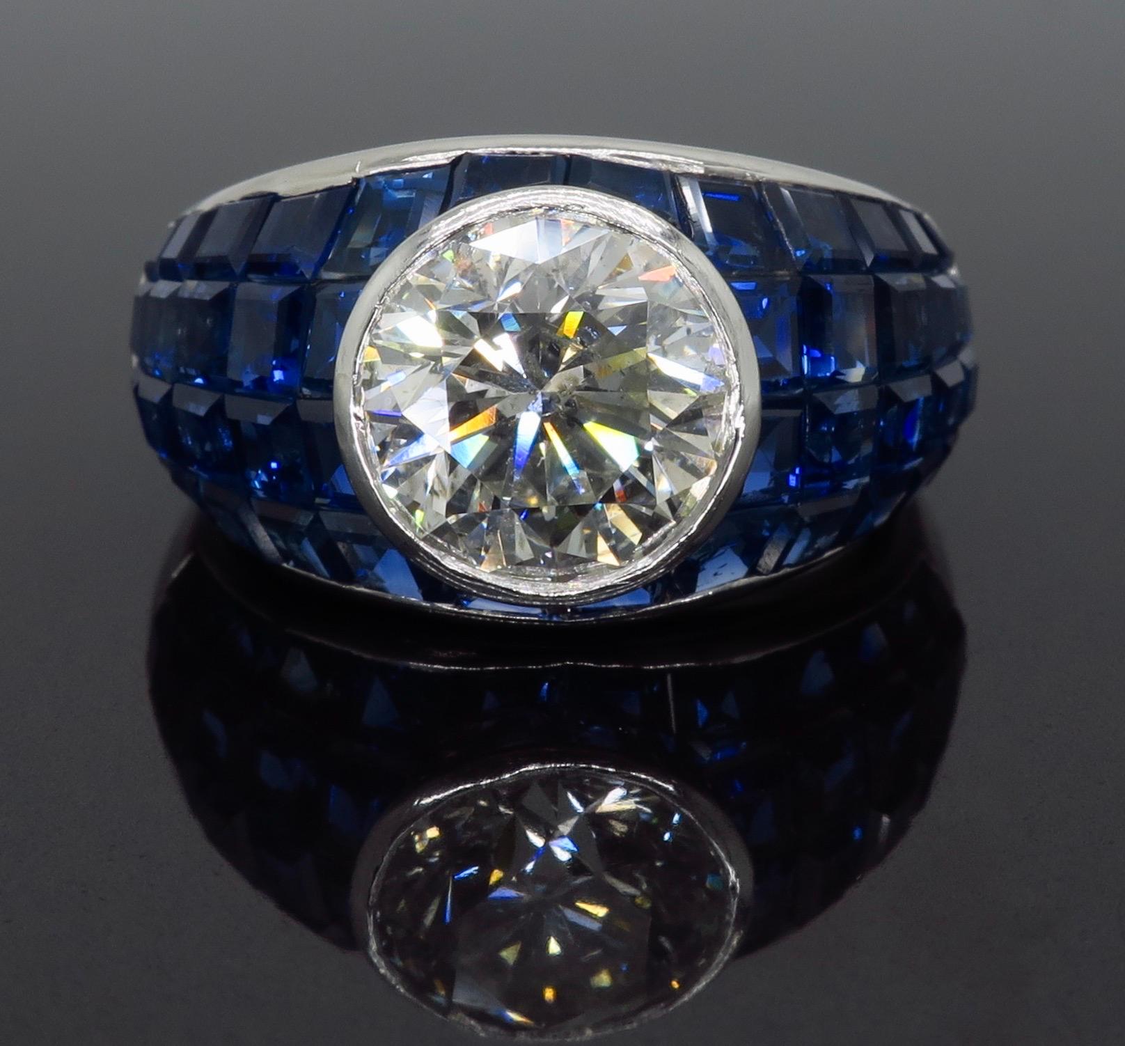 Vintage approximately 2.62CT Round Brilliant Cut diamond ring with blue sapphires set in a mosaic design crafted in platinum

Gemstone: Diamond and Sapphire
Gemstone Size: Irregular Cut Blue Sapphires ranging from approximately 2.00-2.4mm in