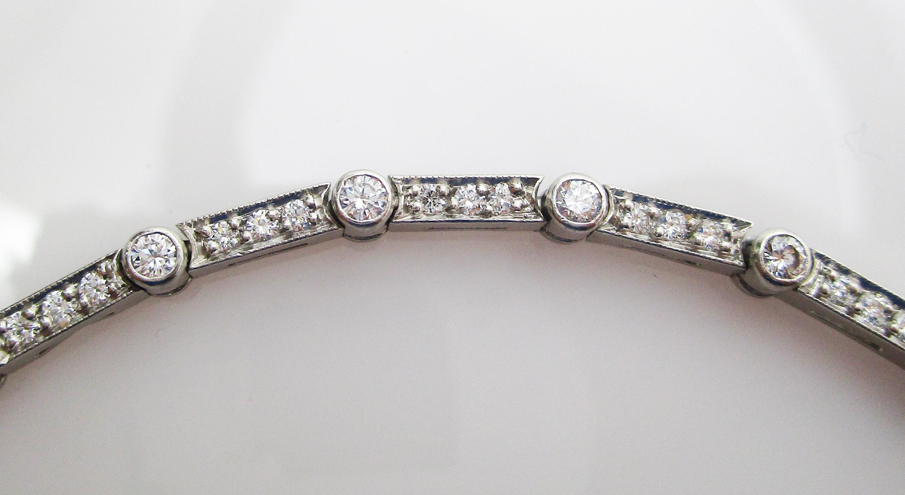 This is a gorgeous Deco style platinum line bracelet with an array of beautiful white diamonds! This unique bracelet has an alternating pattern of round and rectangular links, each set with bright white diamonds. This layout makes the bracelet