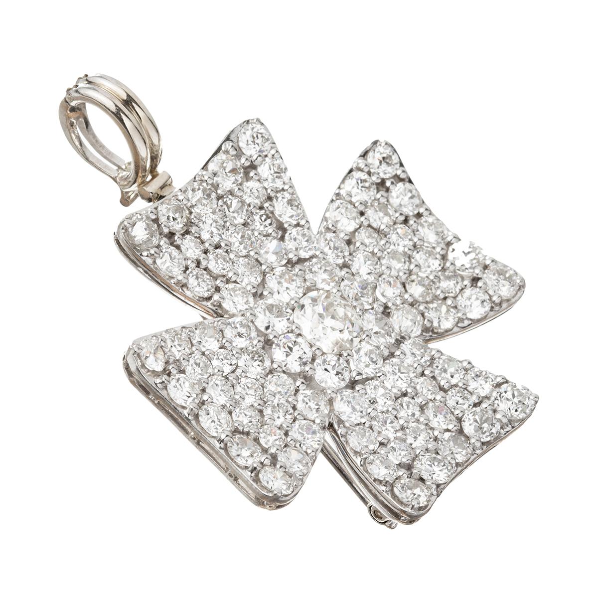 Maltese cross pendant brooch pavé-set with old European and transitional-cut diamonds of various sizes. Handmade in polished platinum. Diamonds weighing approximately 12.80 total carats (old European-cut diamond at center weighing approximately 0.80