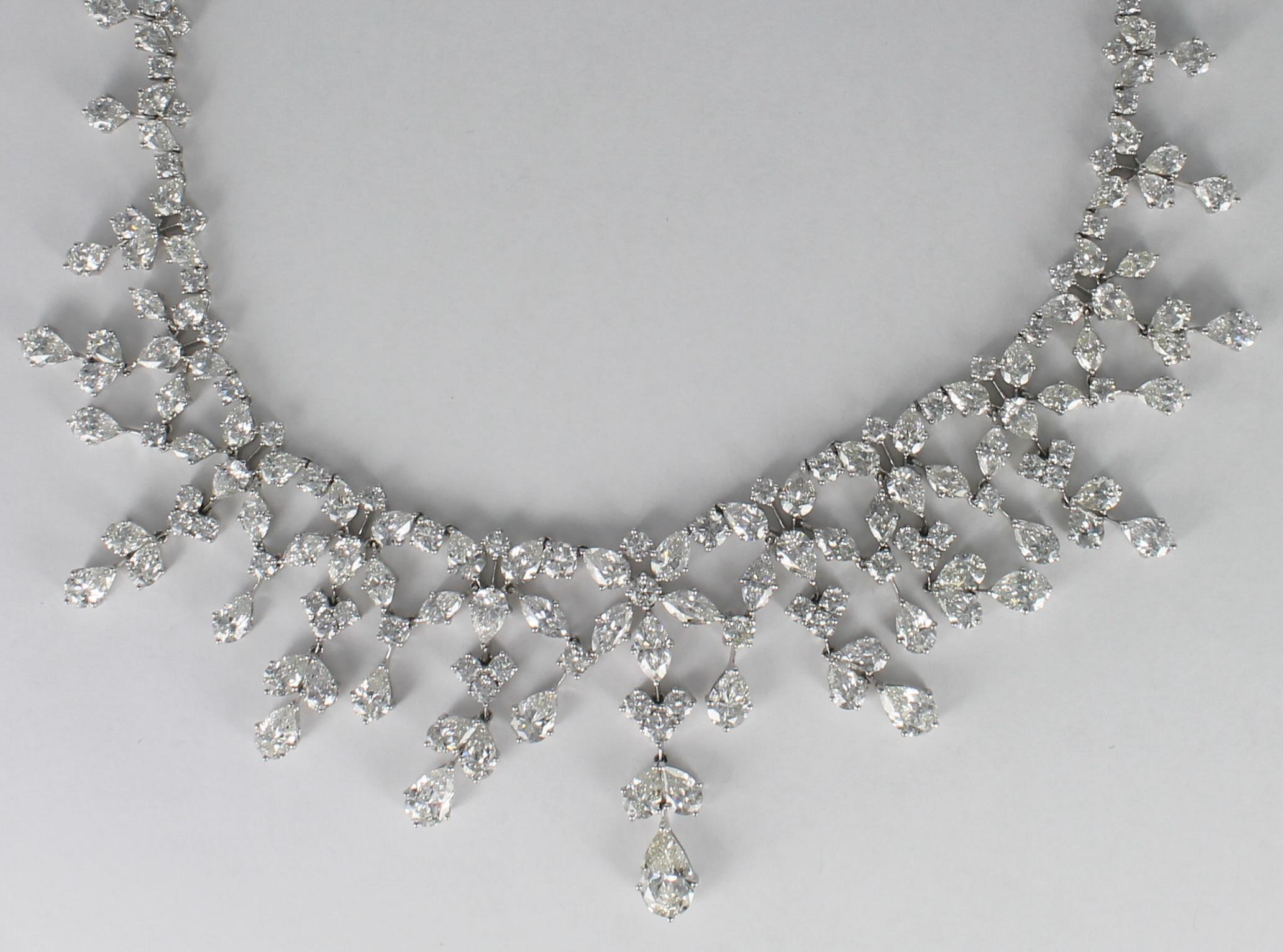 This platinum diamond necklace is poised to light up your special night.  65.65 carats total weight of round and pear-shaped diamonds are masterfully arranged to create this dazzling 16 inch necklace.  The diamonds cascade around the neckline to the