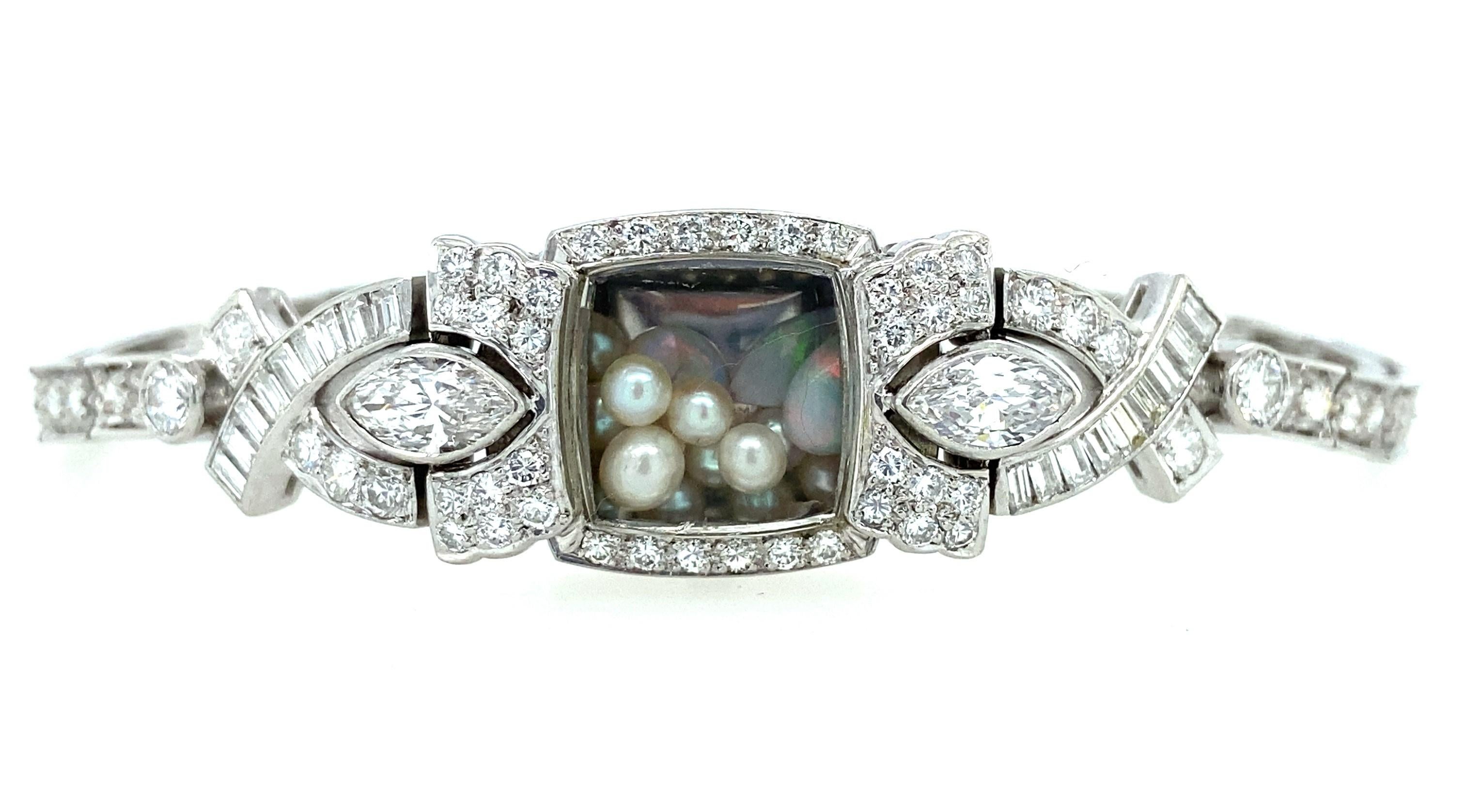 This stunning 1950s diamond bracelet is absolutely one of a kind! Once a woman's watch with a tiny face that was impossible to read, we have removed the movement and replaced it with tiny pearls and 1.09ct of opals that shake and move around like a
