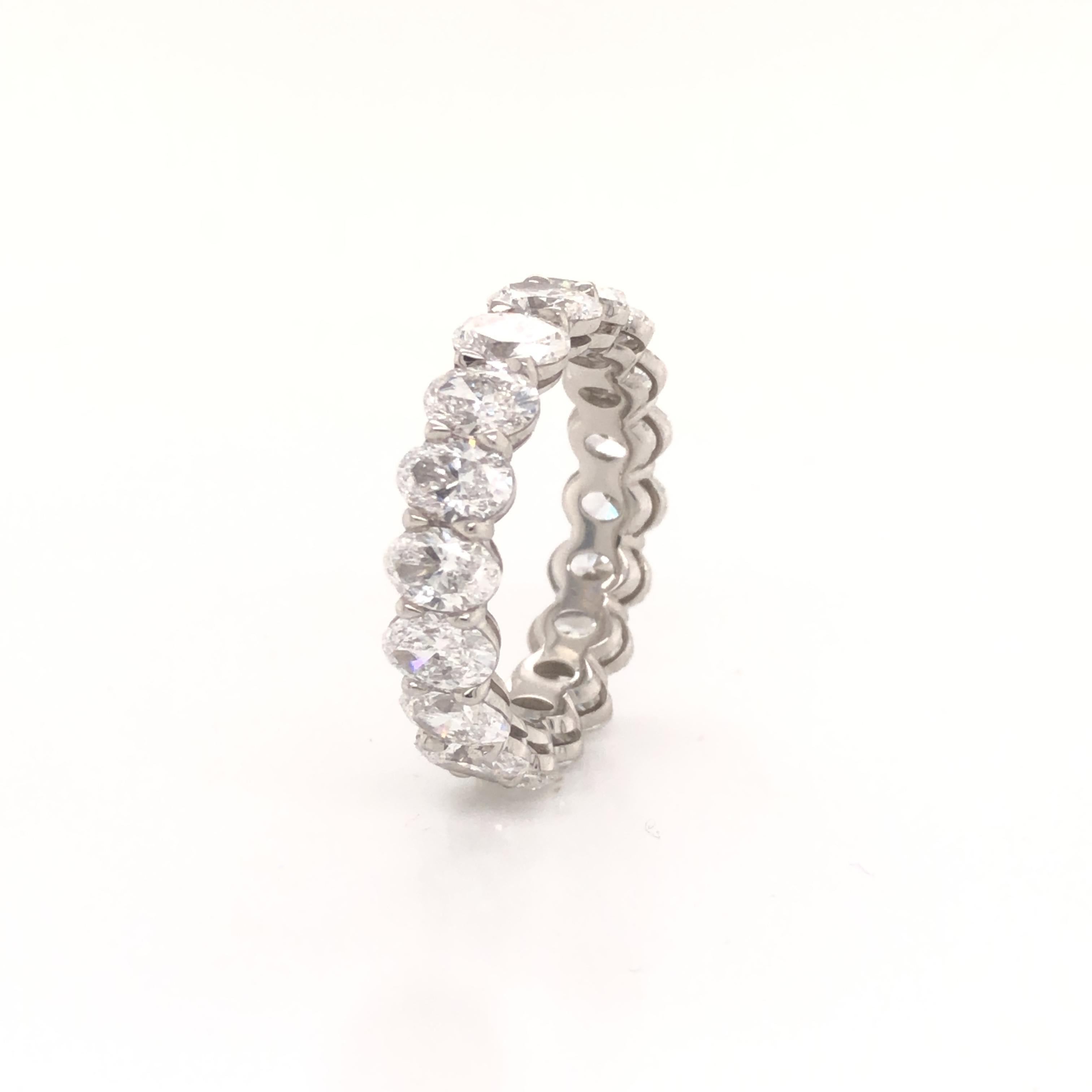 Amazing eternity band crafted in platinum. This gorgeous eternity band is set with oval cut diamonds 18 in total. The ring displays a 5.58 tcw. Each diamond in this ring weigh 0.30-0.35 ct, all diamonds are VVS- VS and shows F-G color. The ring is