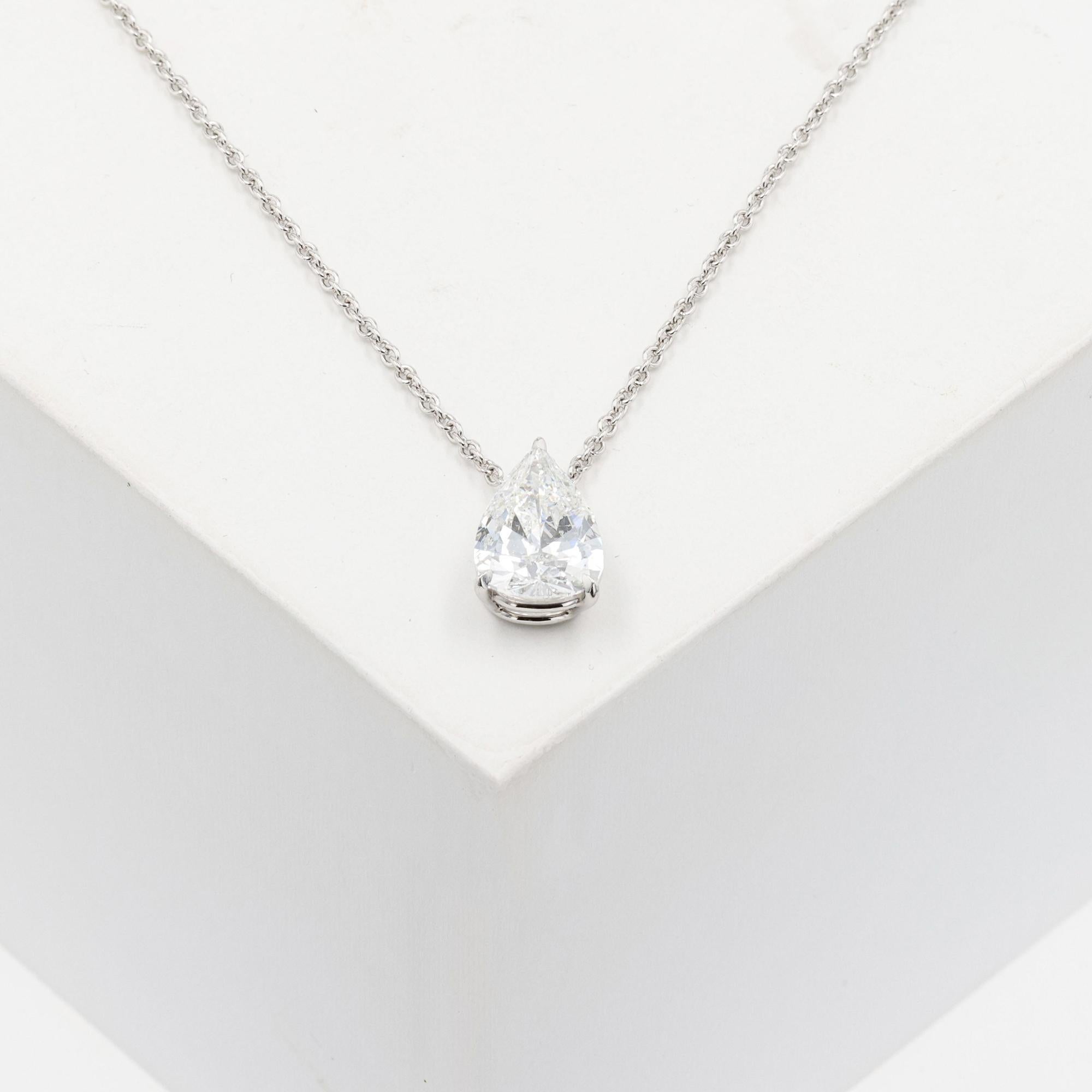 Vintage platinum diamond solitaire pendant. The pear shape diamond weighs 3.39ct.
The diamond is E in color and I1 in clarity. The polish and symmetry are graded
as good. The GIA number is 2221558959, not inscribed. There is a laser drill hole. The