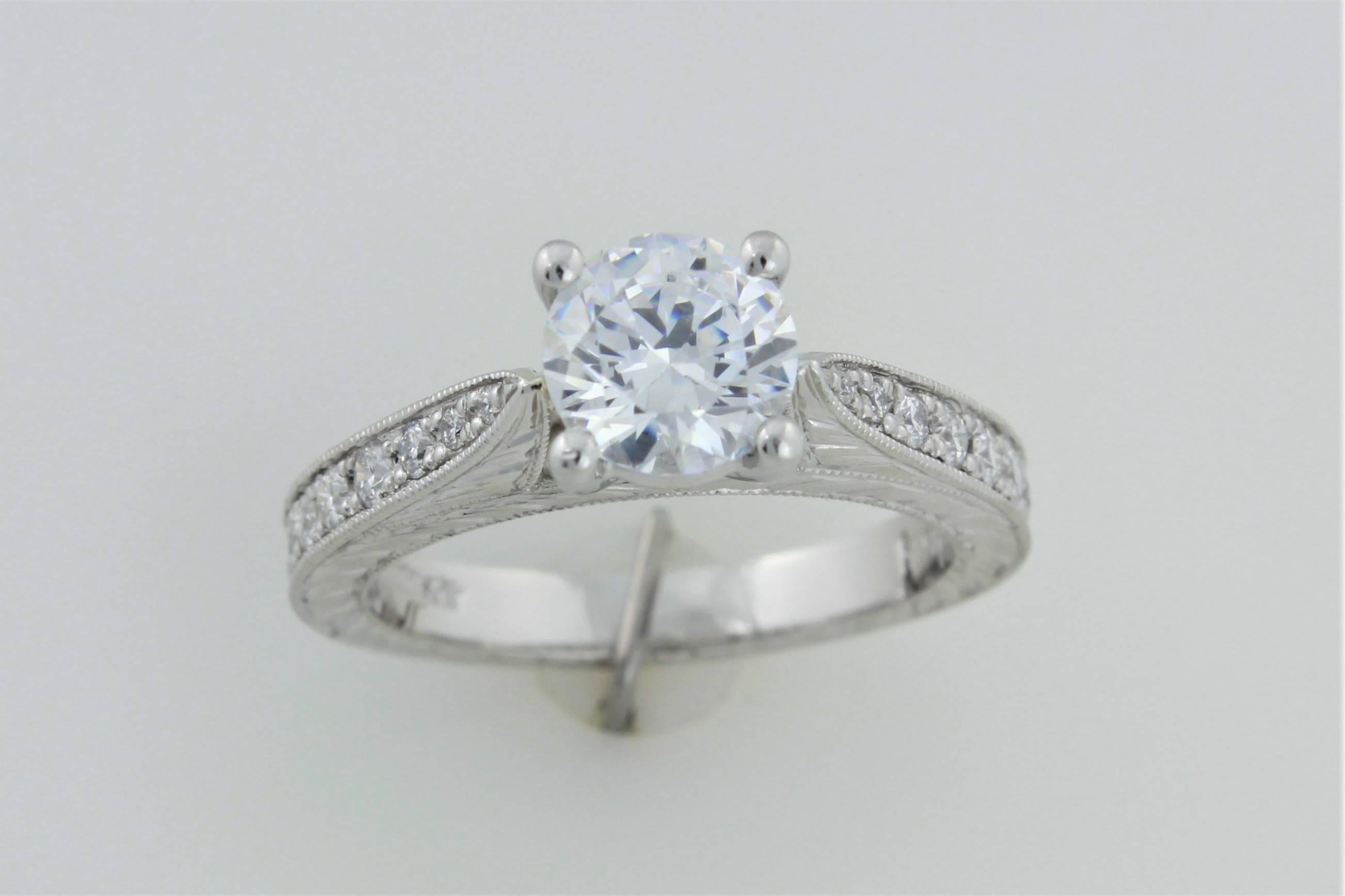 Here is a beautiful platinum Precision Set flush fit ring mounting with .55 carats of G-H Color, VS clarity diamonds.  The center is a cubic zirconia so this is a perfect ring to reset your center diamond into a new frame!!   Both outsides of the