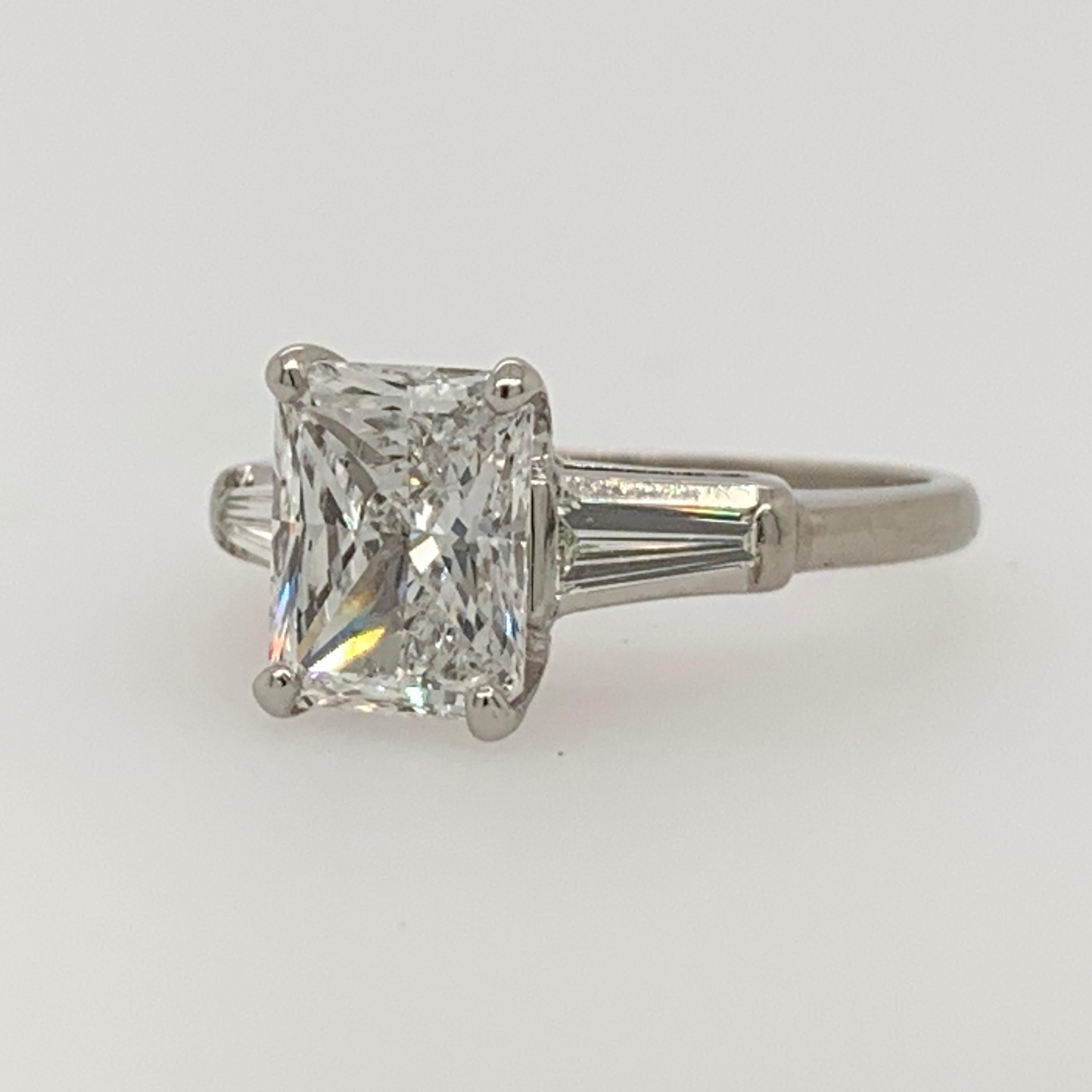 Platinum Ring Radiant cut 2ct total weight. The centerstone is 1.80 carats , D in color and SI2 in clarity by EGL USA. Measuring an impressive 8.43x6.67x3.89mm, it looks like a larger stone. 

The tapered baguette sidestones are approximately 0.20