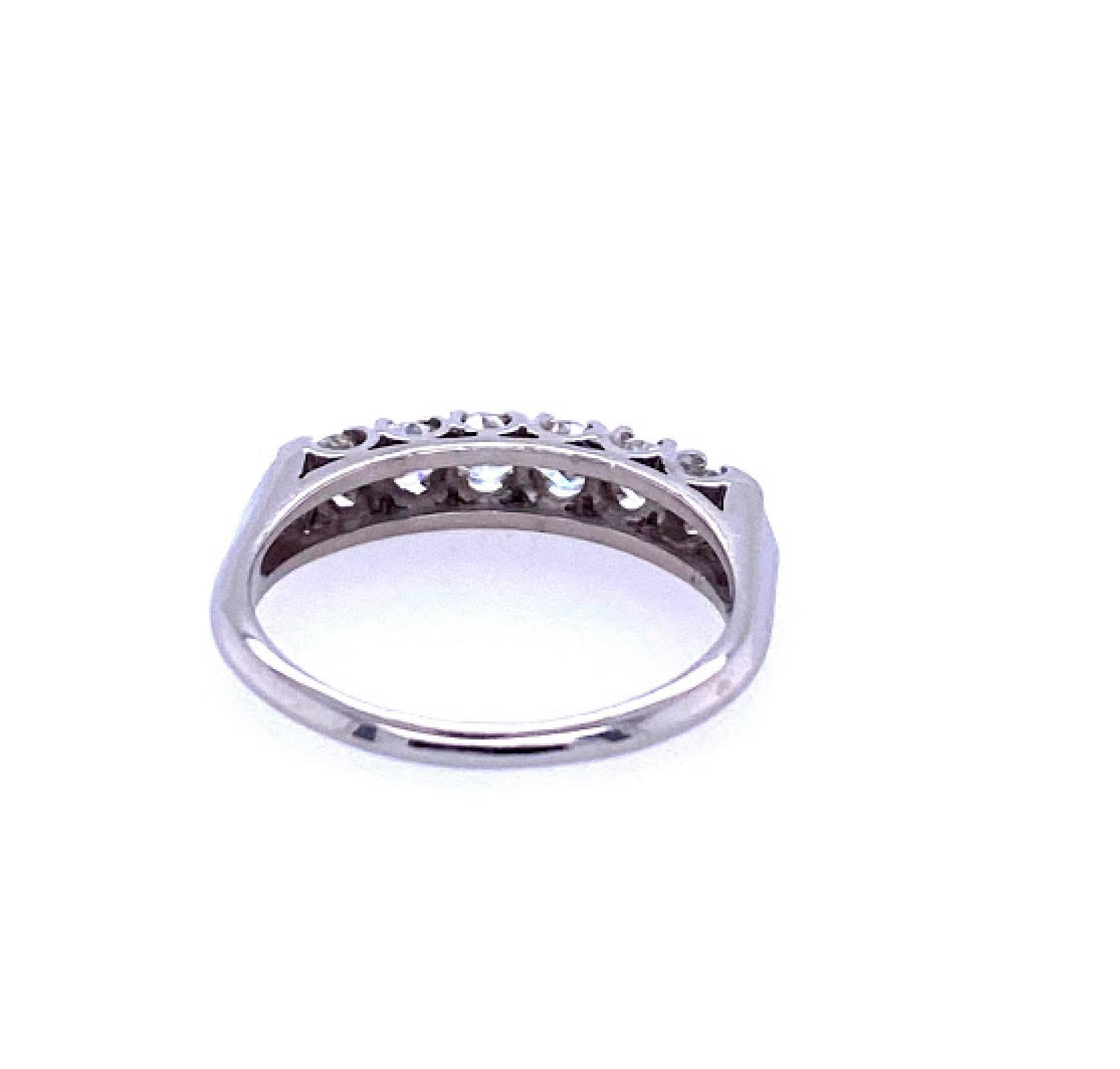 Platinum (stamped 10% IRID PLAT) ring with 6 prong set round brilliant diamonds. The diamonds weigh 0.75 carat total weight, and are in the H/I color range, and SI clarity. The ring’s shank measures 3.5 mm and tapers to 1.5 mm at the base. The ring