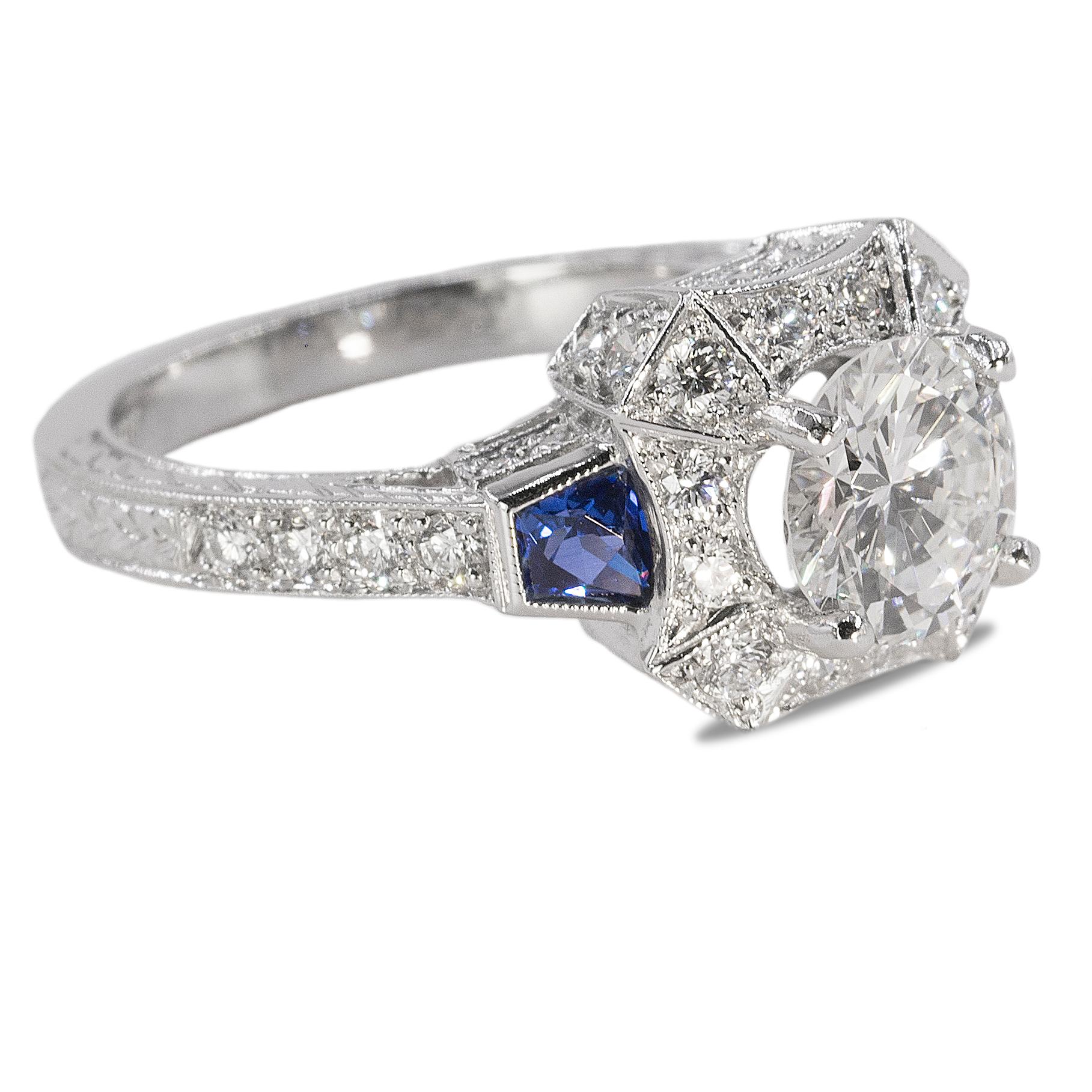 Platinum engraved Ring with GIA certified 1.41 carat I color SI2 clarity round brilliant and 2 sapphires weighing 0.45 and 42 round diamonds weighing 0.85 carats. 