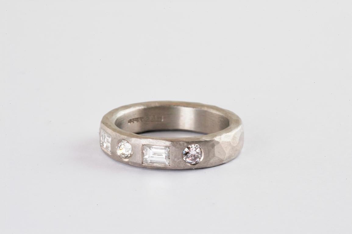 Platinum 5mm ring with round brilliant cut and baguette cut diamonds 0.86cts total , handmade in Notting Hill, London by British jeweller Malcolm Betts. 
Betts' distinctive hammered finish compliments the clean lines of the baguette cut diamonds,