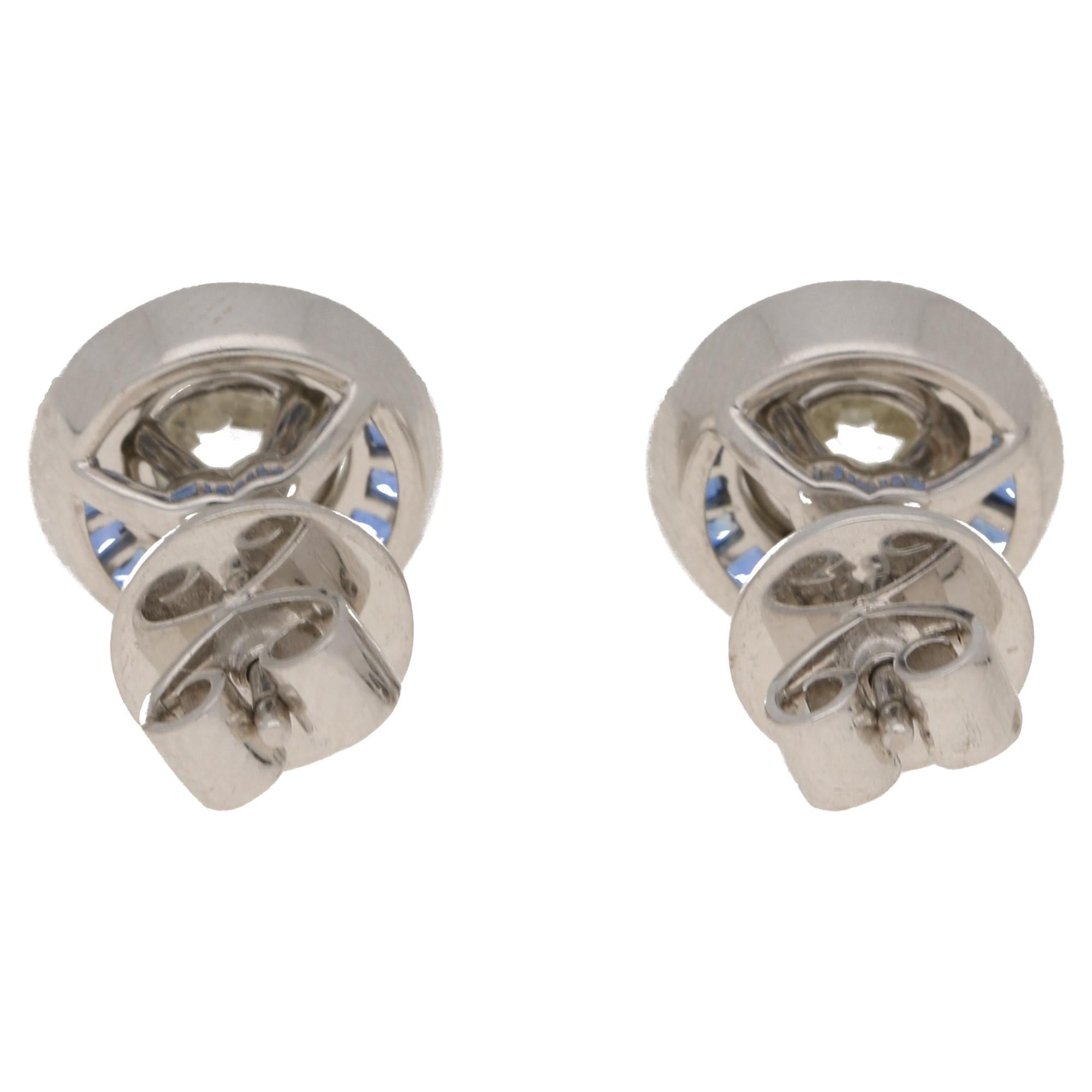 A distinctive pair of convertible diamond and sapphire stud earrings in platinum. With a Deco-inspired target design, these earrings feature a three claw-set Old European brilliant-cut diamond each with a combined weight of 2.09 carats, J/K colour