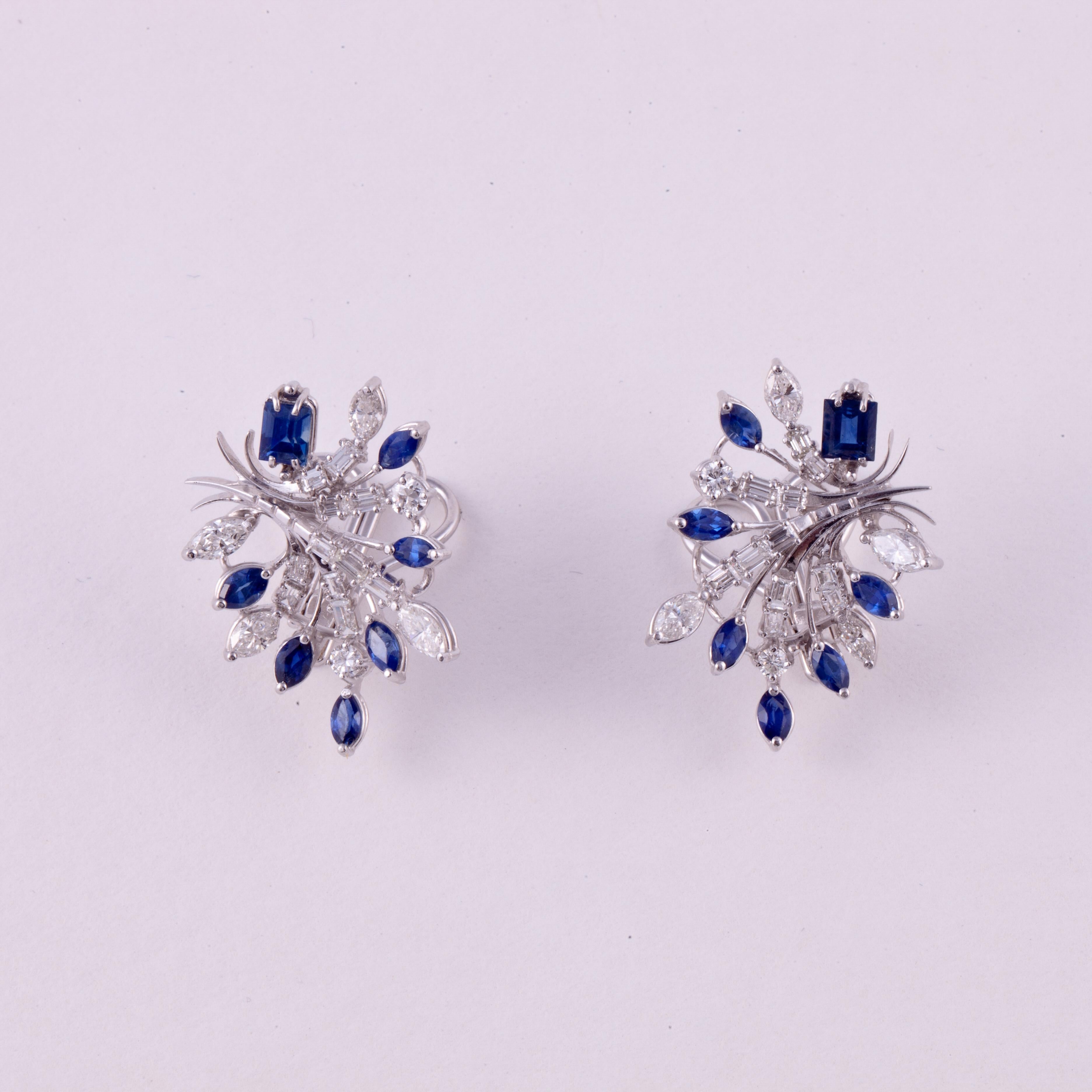 Platinum cluster earrings set with different shapes of diamonds and sapphires.  There are thirty-six (36) diamonds totaling 2.50 carats; F-H color and VS1-VS2 clarity.  There are also fourteen (14) sapphires which total 3 carats.  Measure 1 1/8