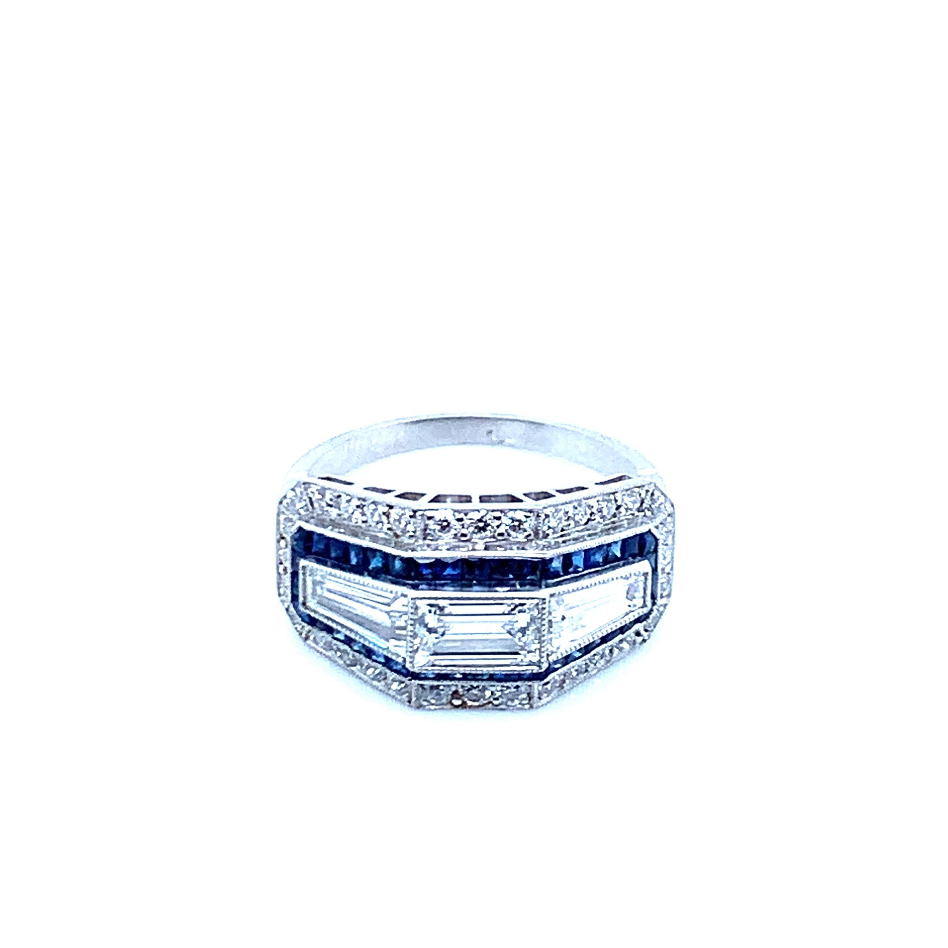 Platinum ring with 1 diamond that weighs 0.55 carat, 2 baguette cut diamonds that weigh 0.85 carat, 38 old mine cut diamonds that weigh 0.66 carat, and 39 sapphires that weigh 1 carat. An art deco recreation, this ring weighs 6.3 grams. Size 7.25.
