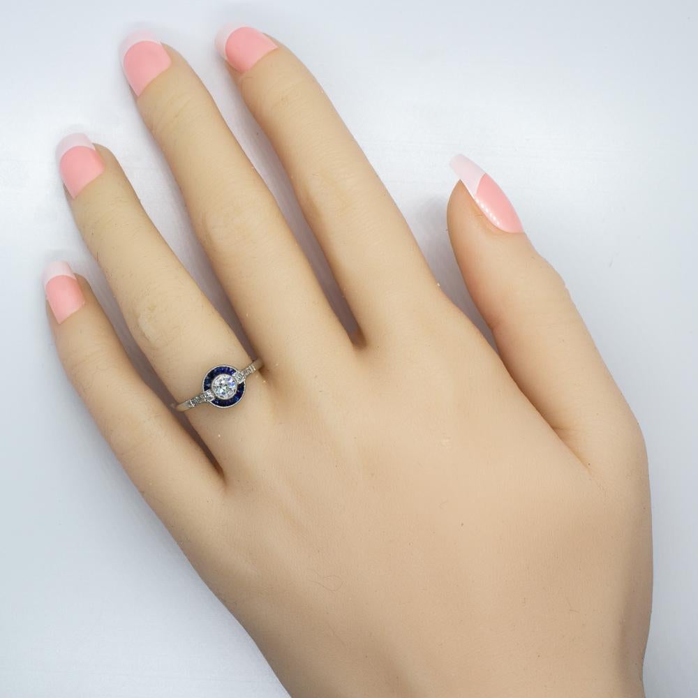 Composition: Platinum
Stones:
•	1 Old mine cut diamond of H-VS2 quality that weighs 0.45ctw.
•	8 Single cut diamonds of H-VS2 quality that weigh 0.10ctw.
•	12 natural French cut sapphires that weigh 0.30ctw. 
Ring size: 6 ¾  
Ring face measurement: 