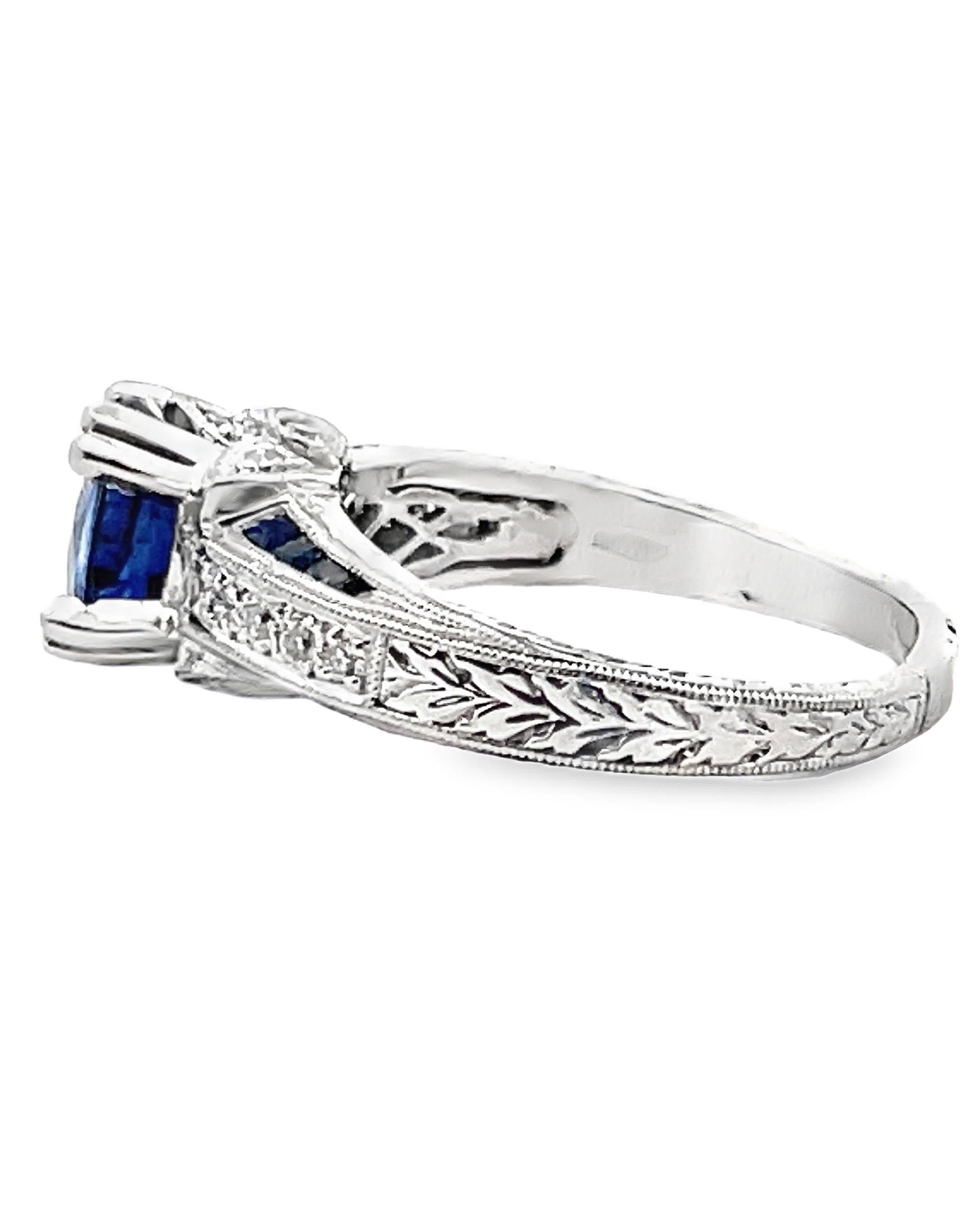 Platinum hand engraved ring furnished with 18 round faceted diamonds weighing 0.25 carat total and 16 step cut sapphires weighing 0.44 carat total. In the center, one round faceted diffused sapphire weighing 2.51 carats. 

- Finger size 7.75 (can be