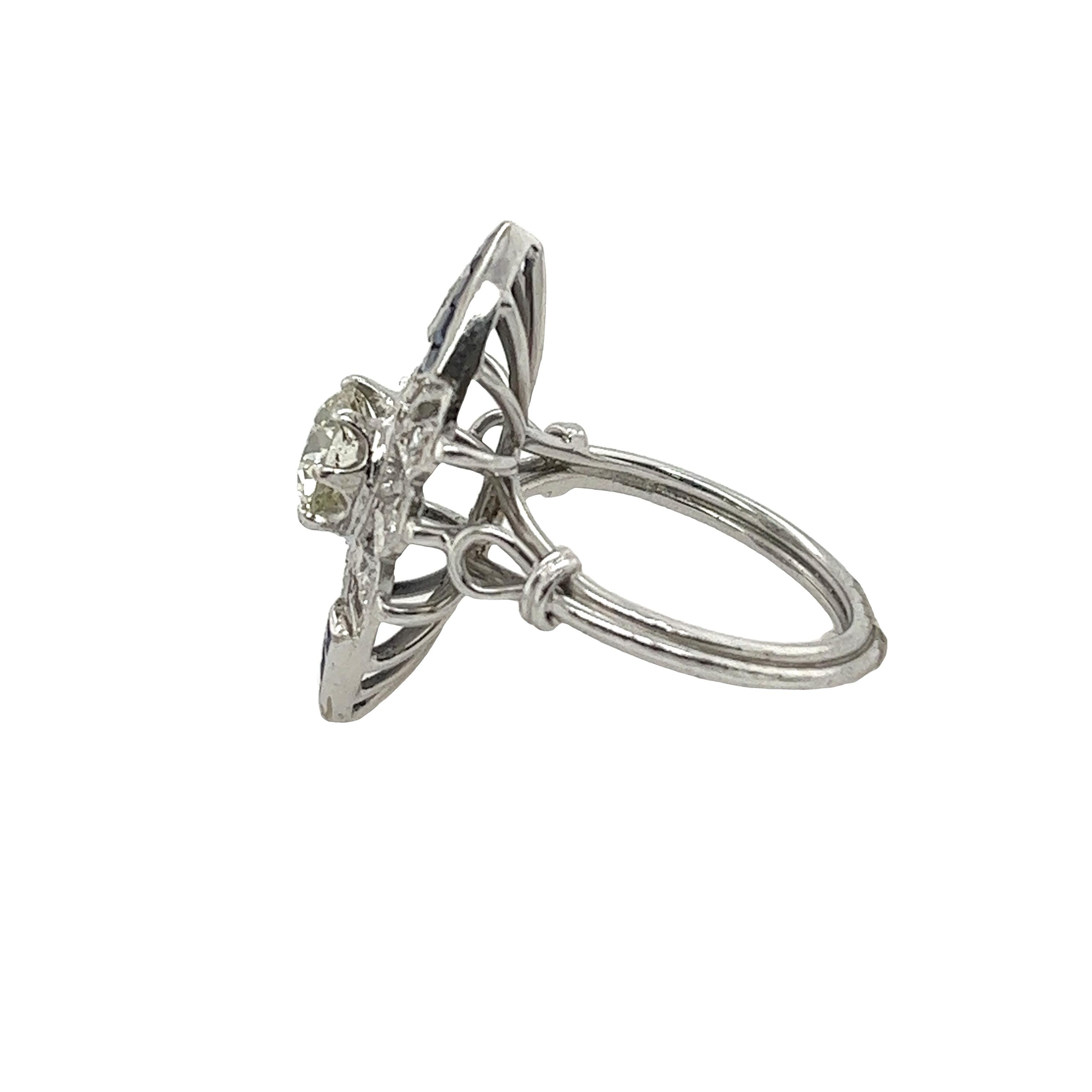 Platinum Diamond & squares sapphires vintage ring is a timeless piece of antique jewelry that exudes elegance and sophistication. 
The ring features a stunning round brilliant diamond at its center, surrounded by 14 vibrant square-cut sapphires that