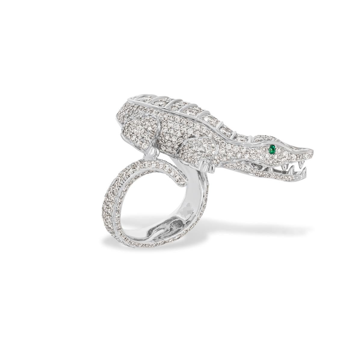 A unique platinum diamond set dress ring. The elaborate ring features a diamond set alligator design with a tail that wraps around the finger. There are 473 round brilliant cut diamonds pave set throughout with an approximate weight of 5.75ct, F-G