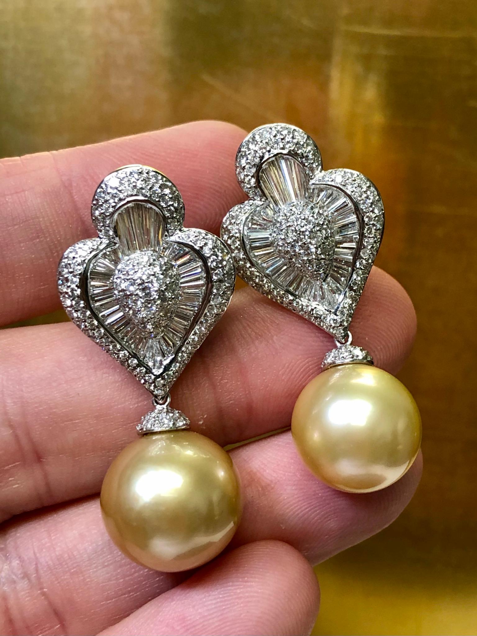 Maybe we are partial, but these earrings are absolutely incredible! They are newly made (never worn) in 18k gold and set with approximately 6.50cttw in H-I color and Vs1 to Si1 clarity round and oversized, calibrated baguette diamonds. The bottom