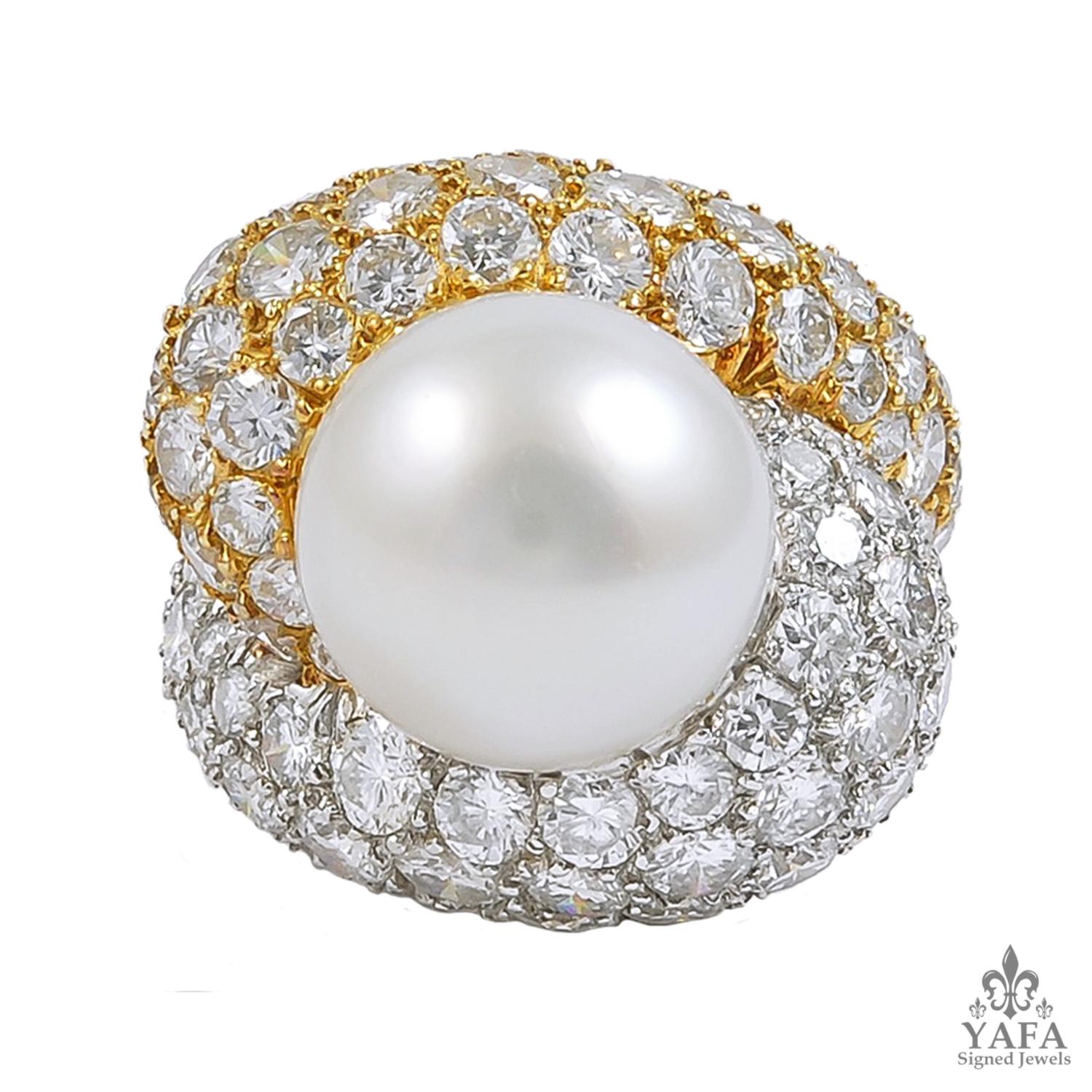 A piece that dates back to the 1980s, comprising an elegant two tone ring with an exceptional twist design, with one half crafted in platinum and the other half in 18k yellow gold, centering a 12.7 mm south sea pearl surrounded by an opulence of
