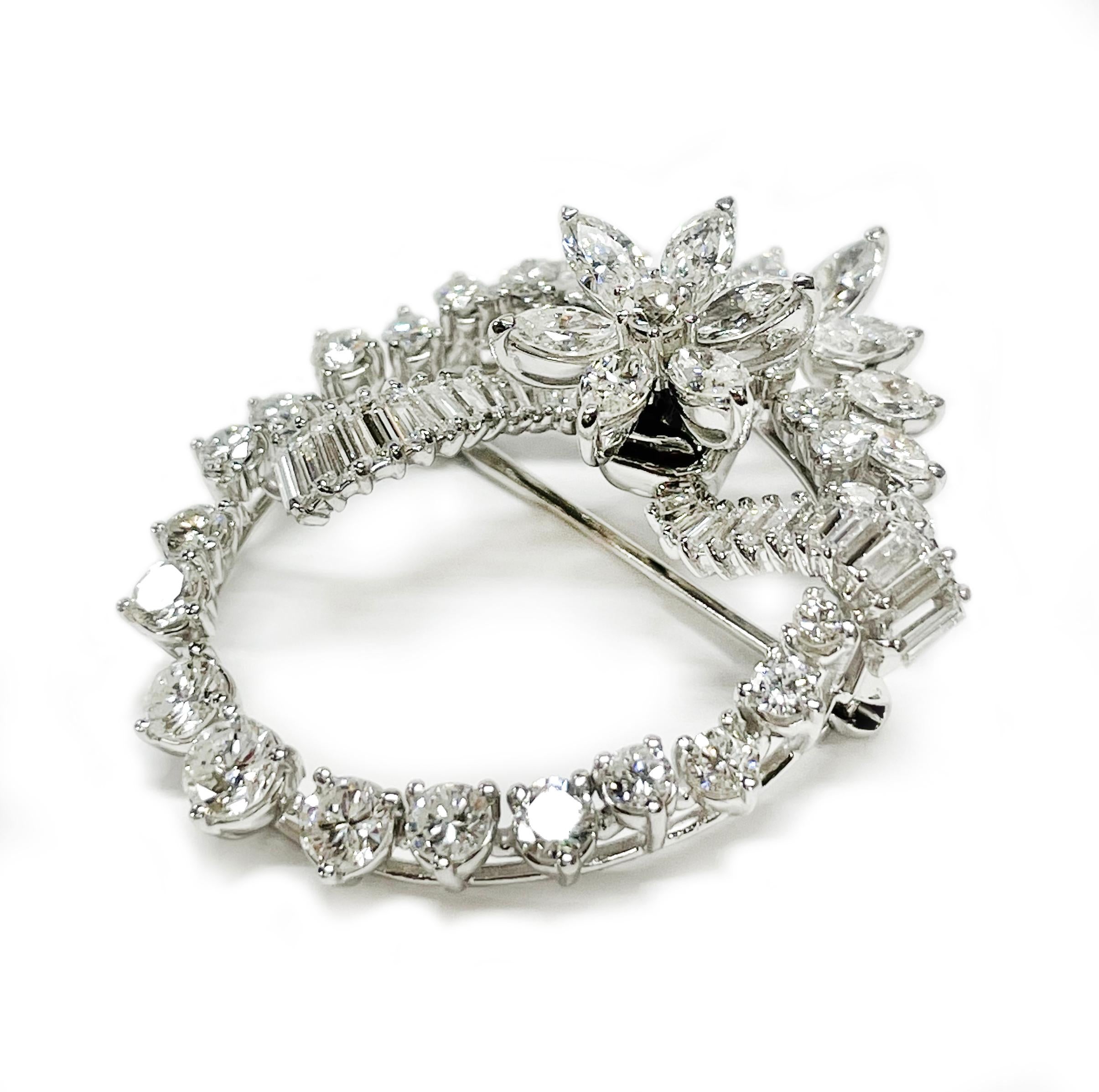 Tested Platinum Diamond Spring Movement Flower Brooch. This is an absolutely gorgeous brooch with an oval platinum frame and prong-set round diamonds, marquise diamonds are set above the oval resembling a crown, the baguettes are set graduate in a