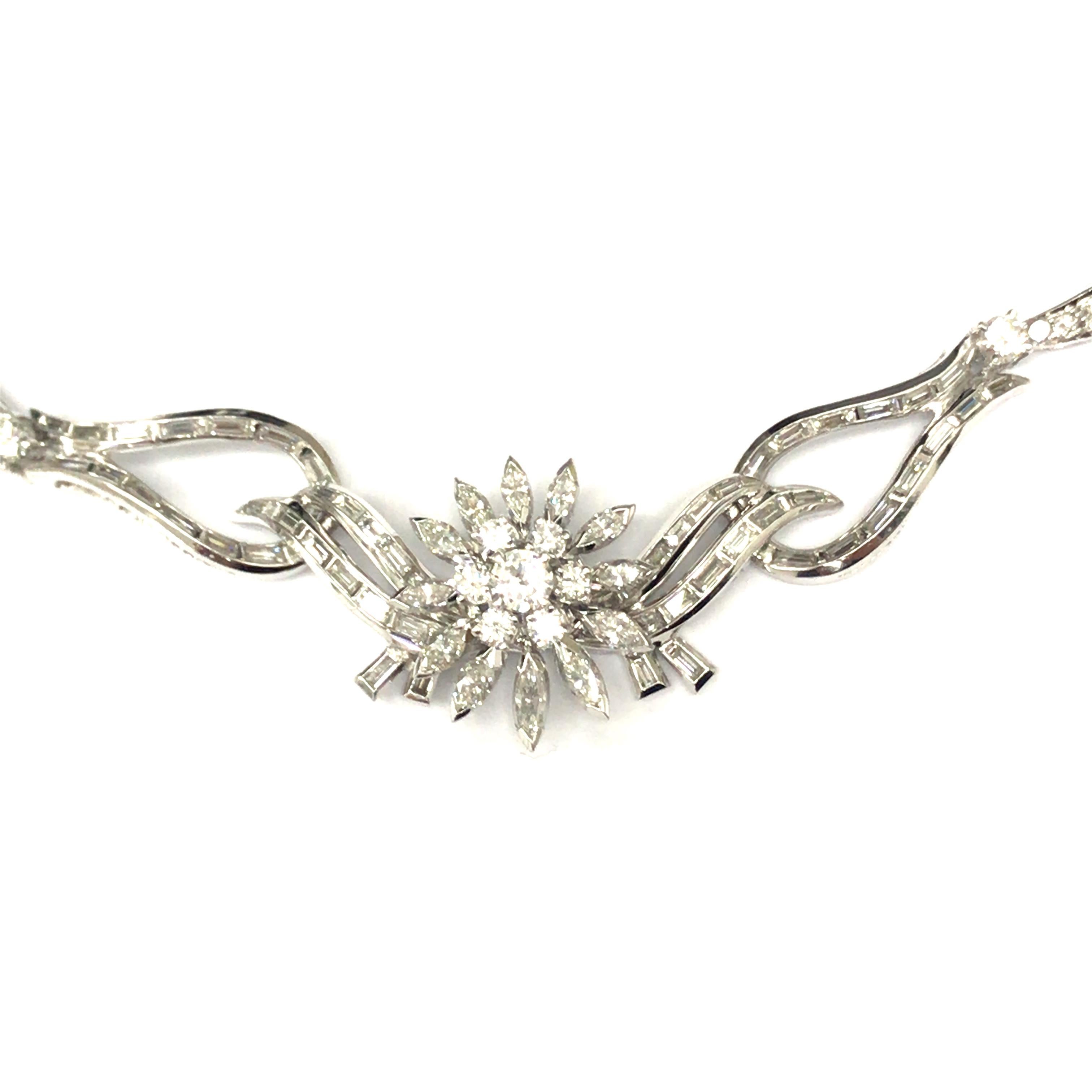 Diamond Starburst Cluster Necklace in Platinum.  Round Brilliant Cut, Marquise and Baguette Diamonds weighing 9.50 carat total weight, G-H in color and VS in clarity are expertly set.  The Necklace measures 15 1/2 inch in length and 3/4 inch in