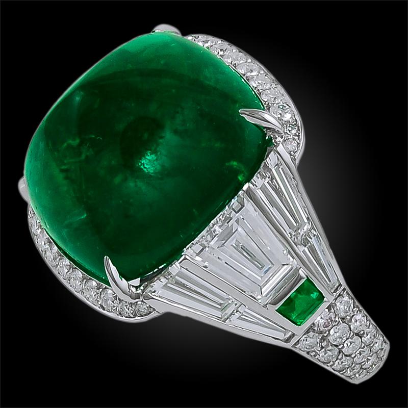 A magnificent and resplendent ring comprising a Sugar Loaf Colombian Emerald at the center of several luminous round and baguette cut diamonds, finely mounted in platinum.
Emerald comes with SSEF certificate weighing approx. 19.82 cts.